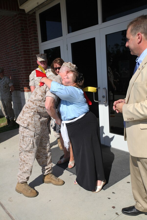 MARINE CORPS BASE CAMP LEJEUNE, N.C. – Col. Kenneth M. DeTreux, the commanding officer of 8th Marine Regiment and native of Philadelphia, Penn., hugs Rebecca A. Yale from Meherrin, Va., after cutting a ribbon to reopen and rename the Wallace Creek Dining Hall in her son’s name Aug. 28, 2014, aboard Marine Corps Base Camp Lejeune, N.C. Corporal Johnathan T. Yale and Lance Cpl. Jordan C. Haerter died protecting their fellow Marines in Iraq when they stopped a truck loaded with 2,000 pounds of explosives before it reached its intended target in April 2008. Both Marines were posthumously awarded the Navy Cross for heroism. (Marine Corps photo by Lance Cpl. Michelle M. Mohn)