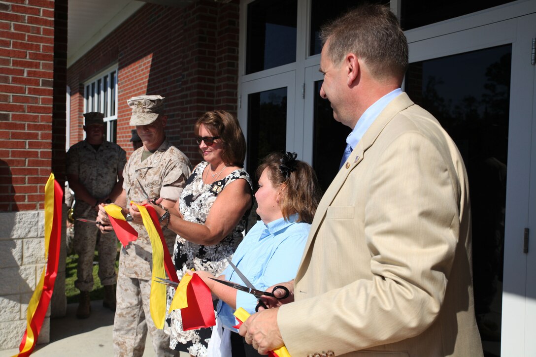 MARINE CORPS BASE CAMP LEJEUNE, N.C. – (From Left) Col. Kenneth M. DeTreux, the commanding officer of 8th Marine Regiment and native of Philadelphia, Penn., along with JoAnn L. Lyles from Sag Harbor, N. Y., Rebecca A. Yale from Meherrin, Va.,  and Christian V. Haerter  from Sag Harbor, N.Y., cut the ribbon to reopen the Yale Haerter Mess Hall, formerly the Wallace Creek Dining Hall, at a dedication ceremony to honor Cpl. Johnathan T. Yale and Lance Cpl. Jordan C. Haerter Aug. 28, 2014, aboard Marine Corps Base Camp Lejeune, N.C. Yale and Haerter died protecting their fellow Marines in Iraq when they engaged and stopped a truck loaded with 2,000 pounds of explosives before it reached its intended target in April 2008. Both Marines were posthumously awarded the Navy Cross for heroism. Rebecca Yale is the mother of Johnathan Yale and JoAnn Lyles and Christian Haerter are the parents of Jordan Haerter.  (Marine Corps photo by Lance Cpl. Michelle M. Mohn)