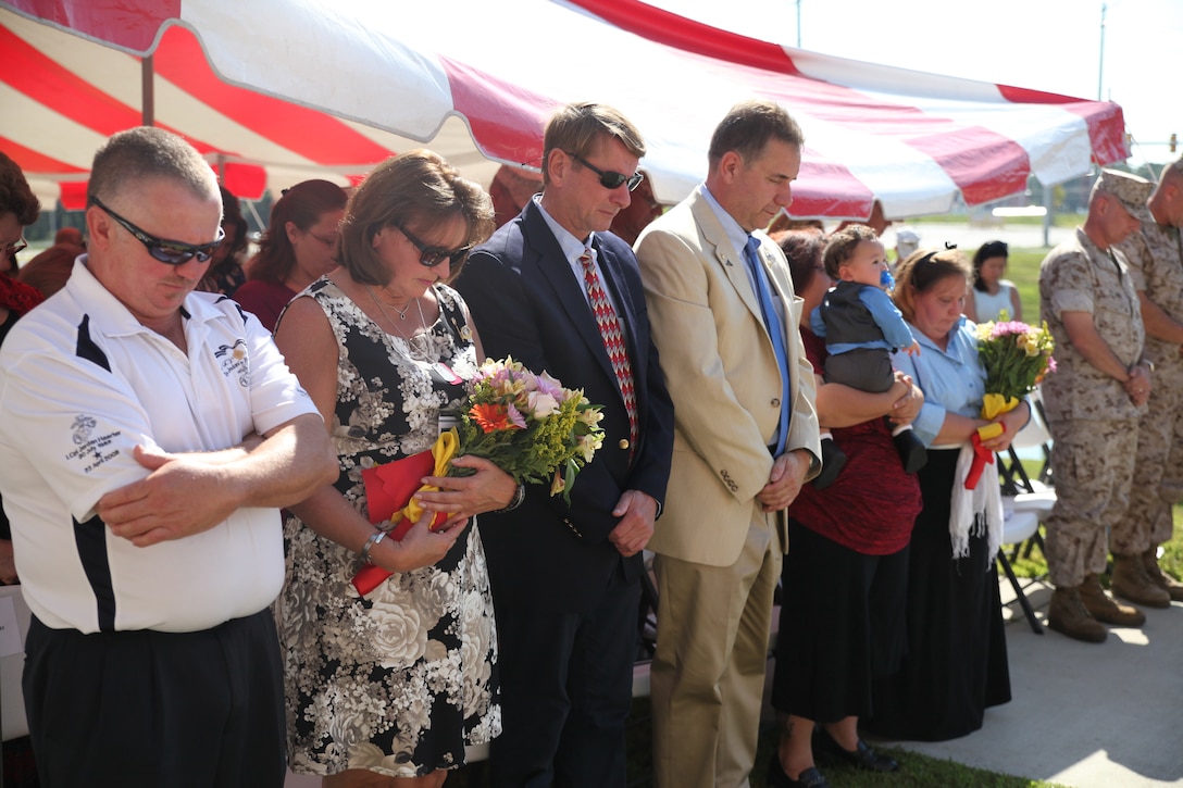 MARINE CORPS BASE CAMP LEJEUNE, N.C. – The families of Cpl. Johnathan T. Yale and Lance Cpl. Jordan C. Haerter bow their heads in prayer during a dedication ceremony to rename the Wallace Creek Dining Hall in honor of the two Marines Aug. 28, 2014, aboard Marine Corps Base Camp Lejeune, N.C. Yale and Haerter died protecting their fellow Marines in Iraq when they engaged and stopped a truck loaded with 2,000 pounds of explosives before it reached its intended target in April 2008. Both Marines were posthumously awarded the Navy Cross for heroism. (Marine Corps photo by Lance Cpl. Michelle M. Mohn)