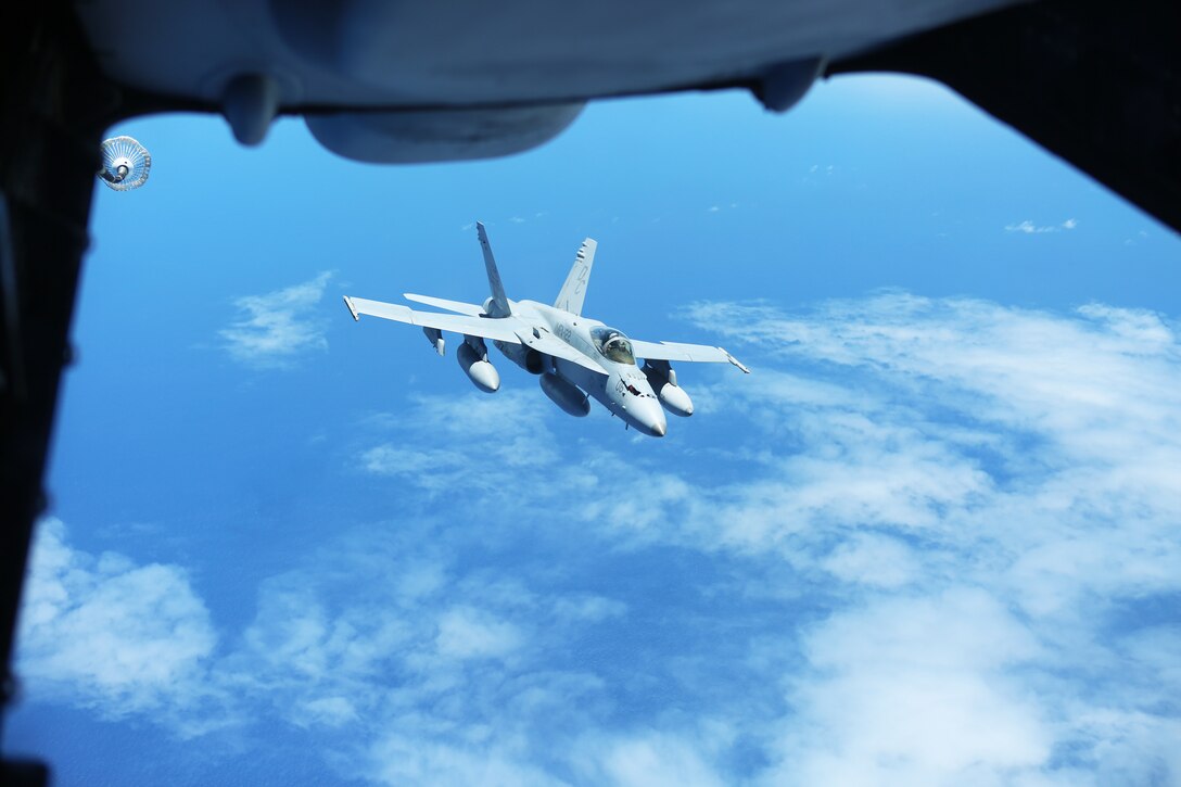 An F/A-18C Hornet with Marine Fighter Attack Squadron 122 completes an aerial refuel from an Air Force KC-10 Extender over the Pacific Ocean, August 23, 2014. The Hornet flew from Hawaii to Eielson Air Force Base in Alaska. While in Alaska, VMFA-122, nicknamed the Werewolves, is scheduled to conduct unit level training and fly with squadrons from the United States Air Force to enhance interoperability between services.  