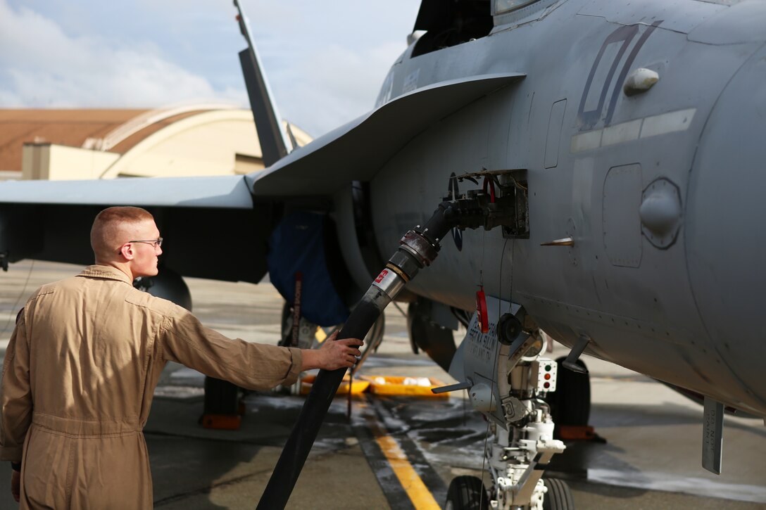 Sgt. Samuel Riley, a fixed-wing aircraft mechanic with Marine Fighter Attack Squadron 122, checks to make sure fuel is flowing to an F/A-18 C Hornet aboard Eielson Air Force Base, Alaska, August 25, 2014. Riley and a crew of Marines prepared the Hornet for its first flight in Alaska. While at Eielson, VMFA-122 is scheduled to conduct unit level training and fly with squadrons from the United States Air Force to enhance interoperability between services.  