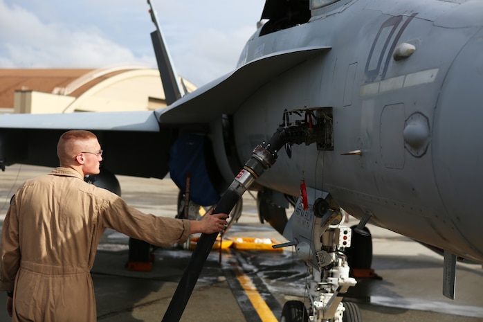 Sgt. Samuel Riley, a fixed-wing aircraft mechanic with Marine Fighter Attack Squadron 122, checks to make sure fuel is flowing to an F/A-18 C Hornet aboard Eielson Air Force Base, Alaska, August 25, 2014. Riley and a crew of Marines prepared the Hornet for its first flight in Alaska. While at Eielson, VMFA-122 is scheduled to conduct unit level training and fly with squadrons from the United States Air Force to enhance interoperability between services.  