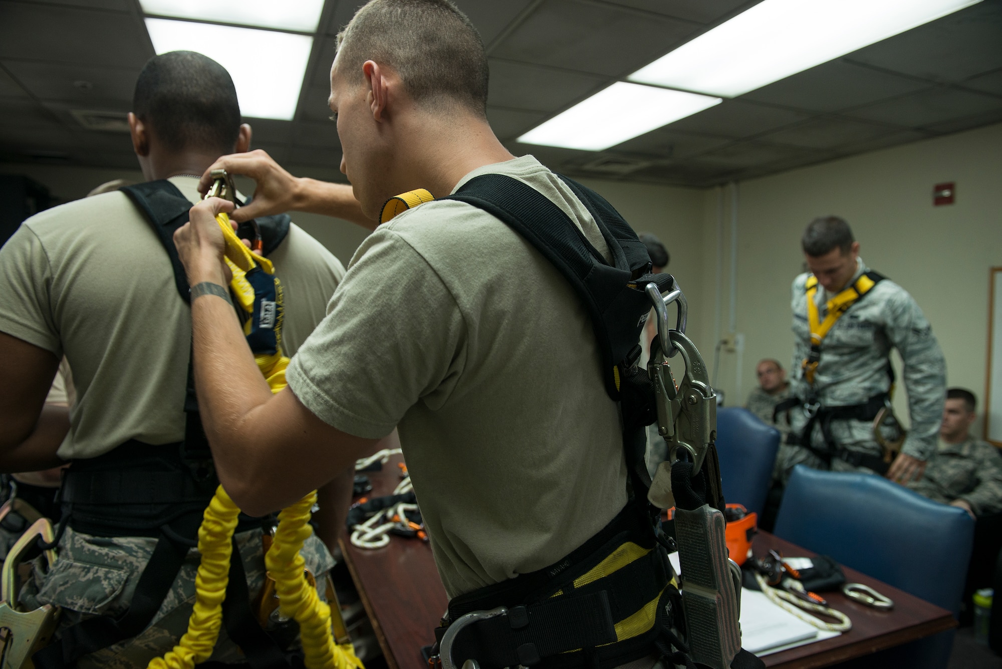 Senior Airman Charlie Hegwer, a 51st Communications Squadron cable and antenna technician, checks one of his student's equipment Aug. 27, 2014, at Osan Air Base, Republic of Korea. Prior to going to an on-site climb, the students must personally test all of their equipment to ensure safety. (U.S. Air Force photo by Staff Sgt. Jake Barreiro/Released)