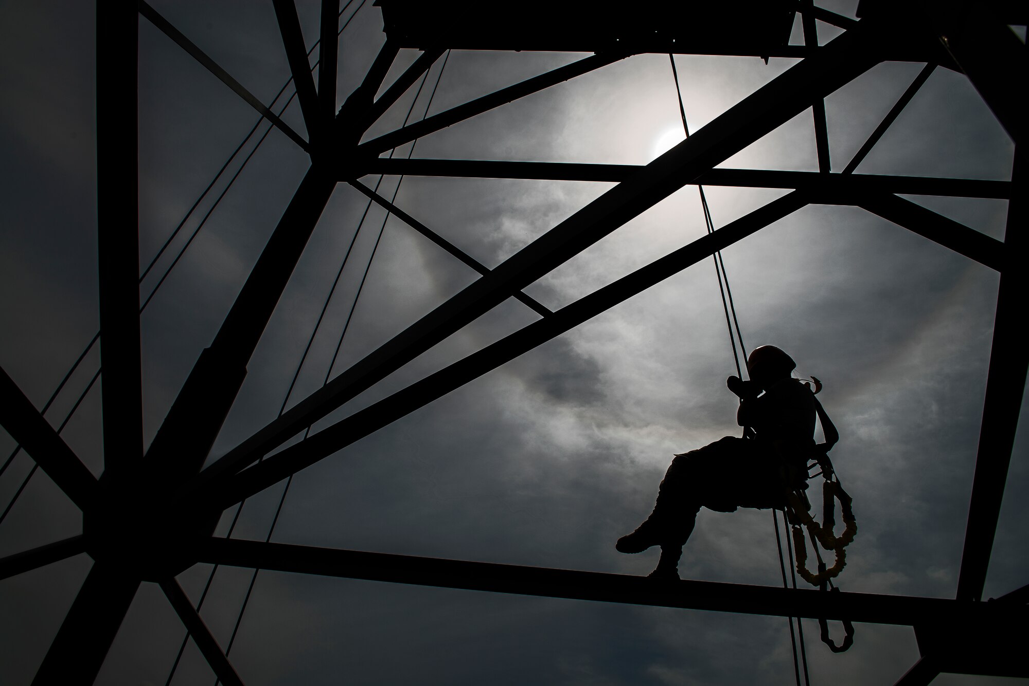 Senior Airman Emma Duff, Armed Forces Network broadcaster, tip toes on a tower beam while rappelling for a tower rescue training class Aug. 27, 2014, at Osan Air Base, Republic of Korea. The tower rescue training was taught by the Airmen of the 51st Communications Squadron, who are required to ascend and descend tall structures such as radio towers as part of their duties.  (U.S. Air Force photo by Staff Sgt. Jake Barreiro/Released)
