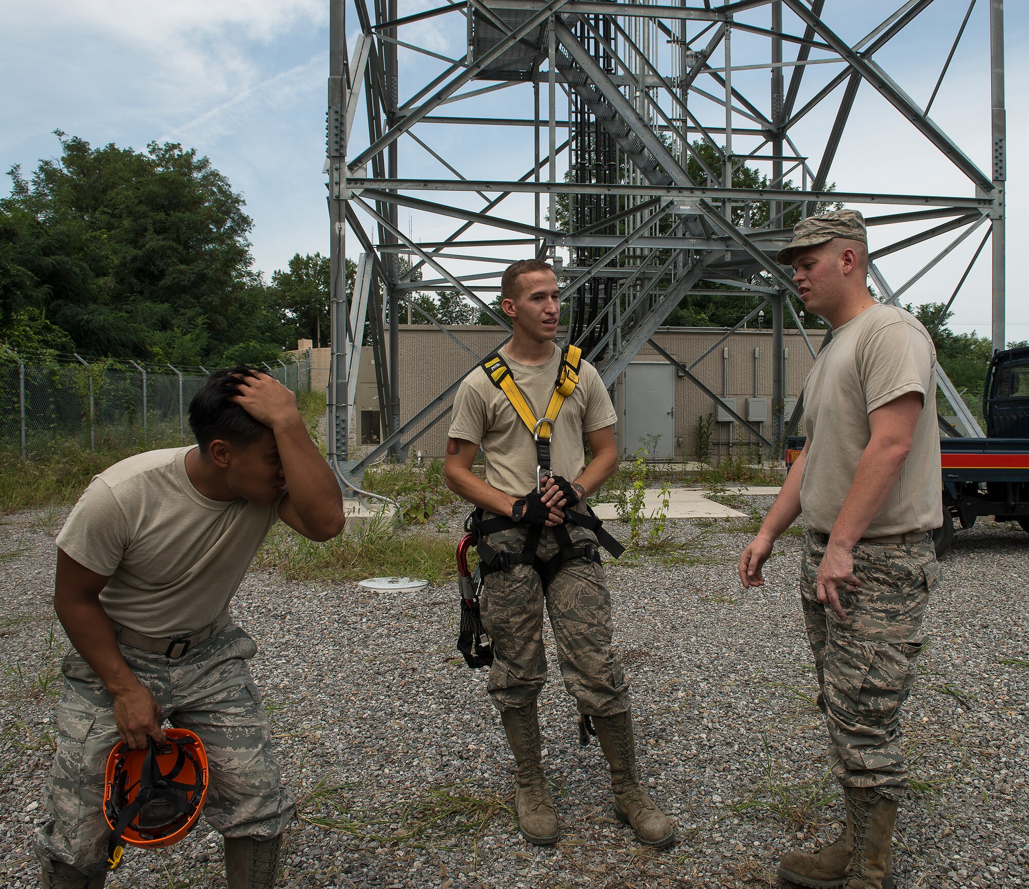 Staff Sgt. Aaron Ramelb and Senior Airmen Charlie Hegwer and Travis Hahn-Holmes, all 51st Commuications Squadron cable and antenna technicians, chat after finishing tower climing and rappelling training Aug. 27, 2014, at Osan Air Base, Republic of Korea. The trio are part of the Cable Dawgs, a handle given to CS Airmen who work in man holes and repair communication lines below the ground. (U.S. Air Force photo by Staff Sgt. Jake Barreiro/Released)