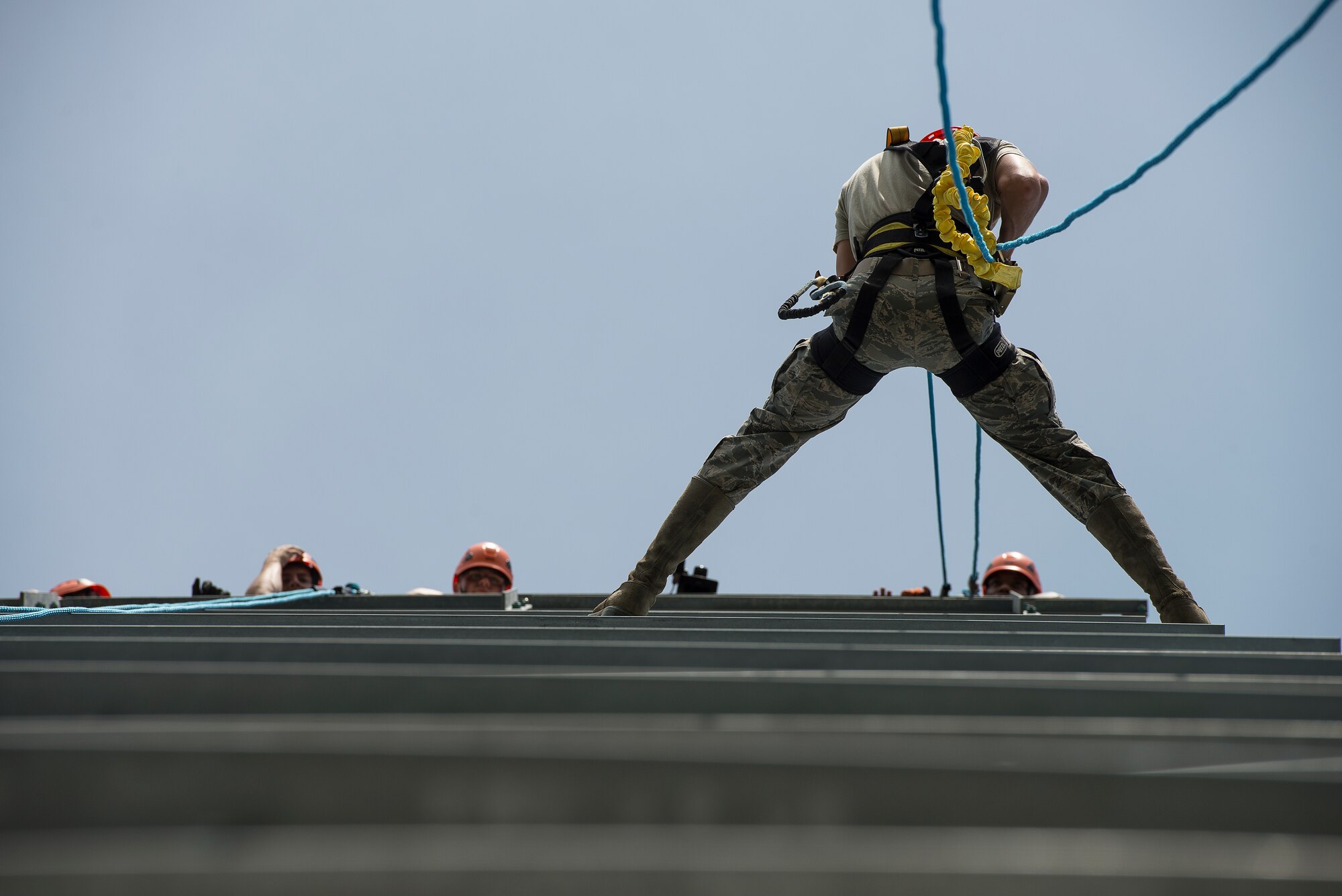 Senior Airman Charlie Hegwer, a 51st Communications Squadron cable and antenna technician, rappels down a tower during a tower climbing and rappelling class Aug. 27, 2014, at Osan Air Base, Republic of Korea. During the training, students are instructed in proper climbing and rappelling techniques before physically demonstrating their capabilities. (U.S. Air Force photo by Staff Sgt. Jake Barreiro/Released)