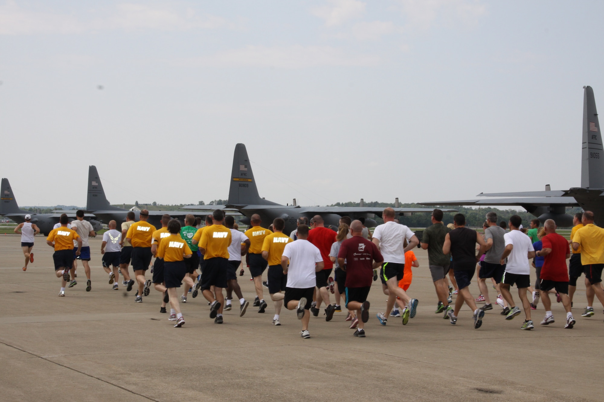 Military members and their families run on the flight-line at the Pittsburgh International Airport Air Reserve Station, August 2, 2014. (U.S. Air Force photo by Staff Sgt. Jonathan Hehnly)