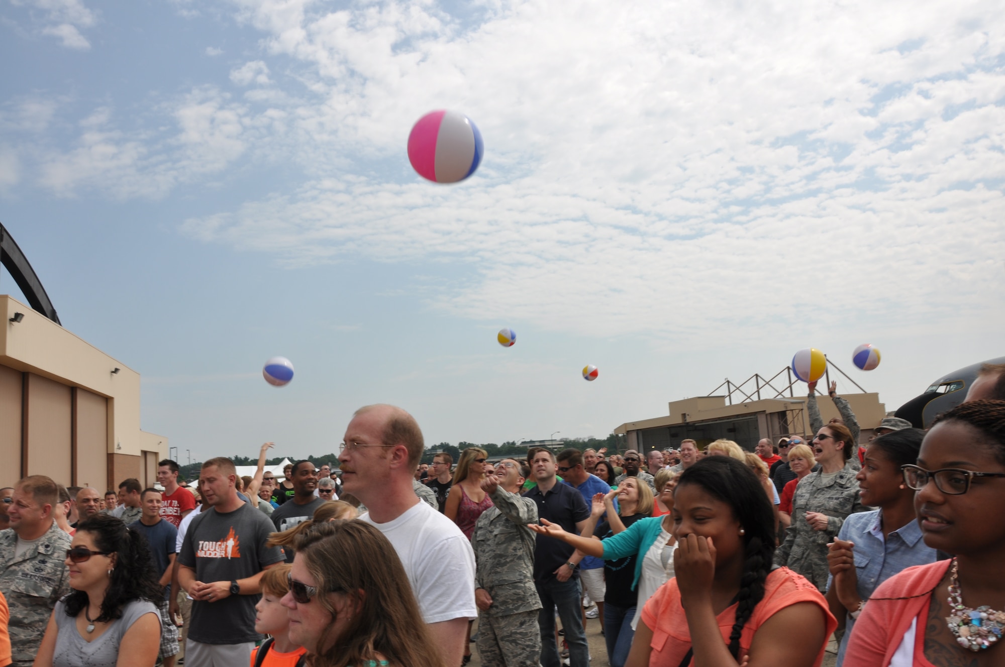 Members of the 911th Airlift Wing and their families bounce beach balls to each other as part of a demonstration during a commander’s call at Pittsburgh International Airport Air Reserve Station, August 2, 2014. (U.S. Air Force photo by Senior Airman Marjorie A. Bowlden)