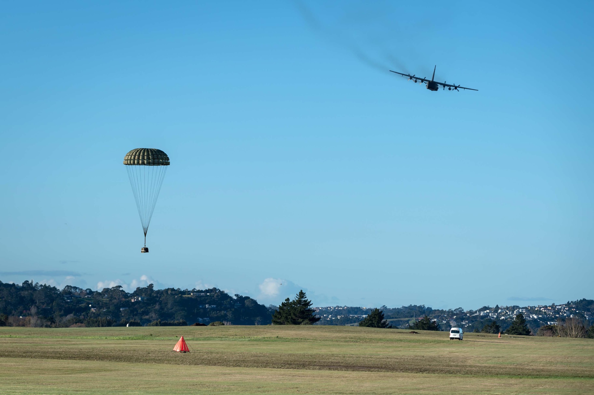 An MC-130H Combat Talon II from the 1st Special Operations Squadron conducts an airdrop July 28, 2014 over a drop zone in New Zealand.   The 353rd Special Operations Group trained side by side with their counterparts in the New Zealand Defense Force during Exercise Balance Net July 17-31.  The exercise enhanced interoperability defense relations between the two countries.  (New Zealand Defense Force Photo by Roderick MacKenzie) 