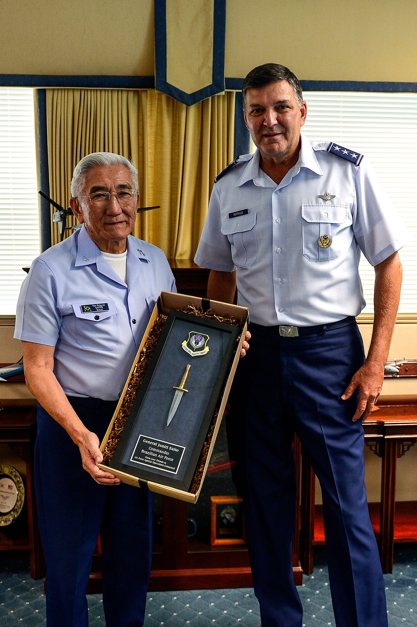Lt. Gen. Brad Heithold, Air Force Special Operations Command commander, presents Gen. Juniti Saito, Brazilian Air Force commander, with a gift at AFSOC Headquarters, Hurlburt Field, Fla., Aug. 22, 2014. Saito is a participant of the Air Force Chief of Staff Counterpart Program, which helps build, sustain and expand relationships with other nations. (U.S. Air Force photo/Airman 1st Class Jeff Parkinson)
