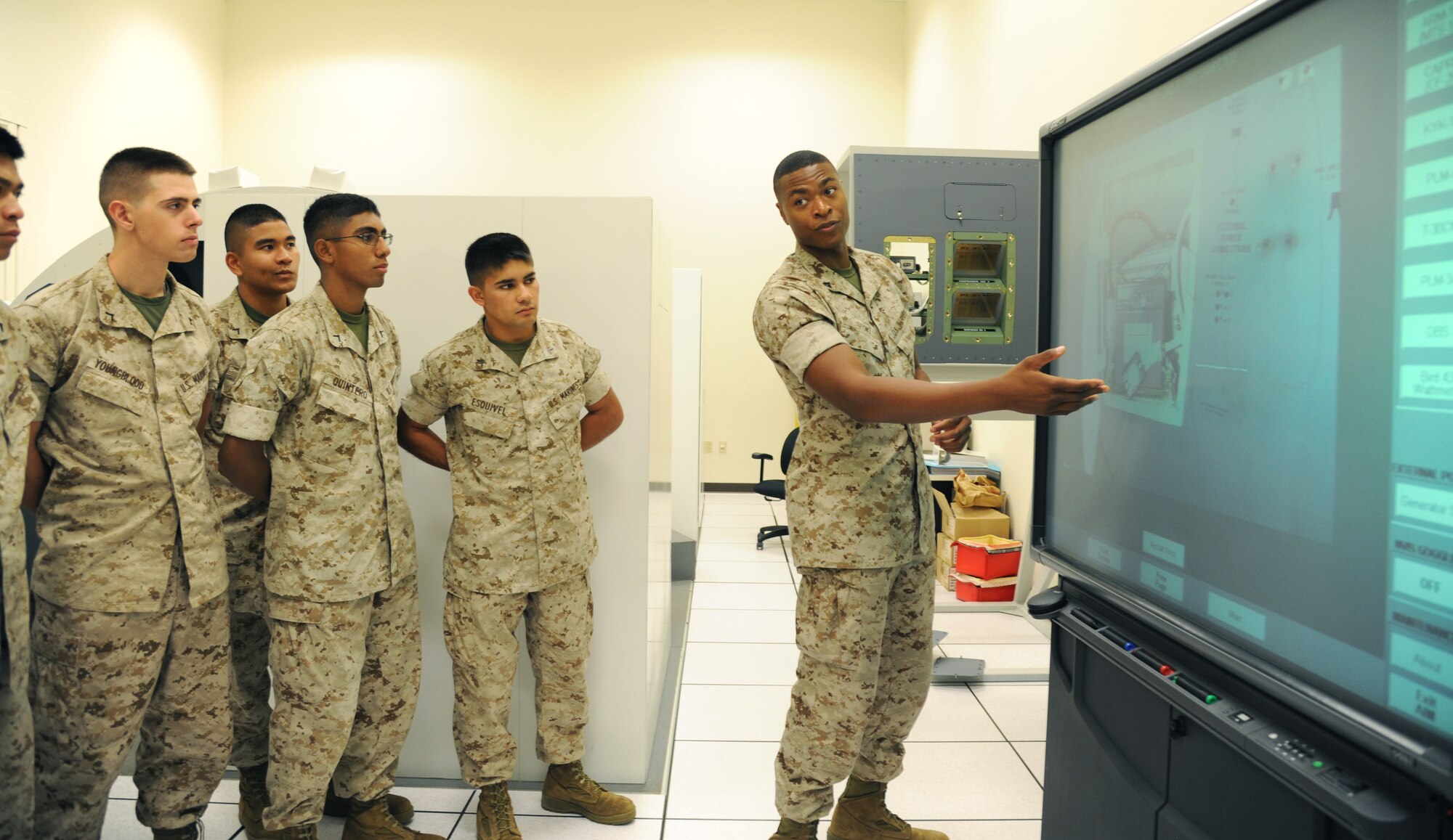 Cpl. Caleb Otoki, an instructor at the Center for Naval Aviation Technical Training, teaches students about battery compartments July 21, 2014, at Little Rock Air Force Base, Ark. Otoki taught the students how to properly check a battery on an aircraft. (U.S. Air Force photo by Airman 1st Class Mercedes Muro) 