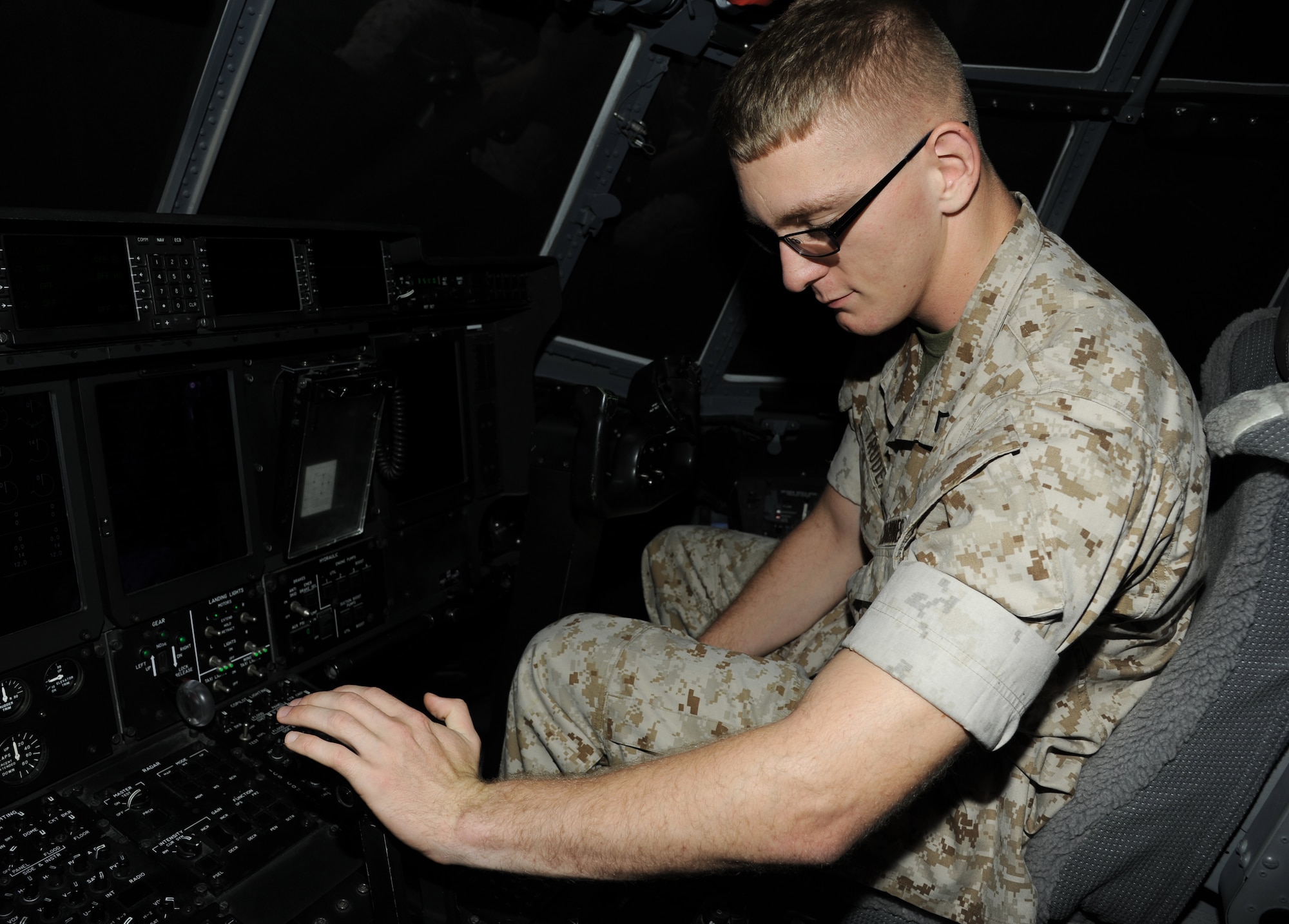 Pfc. Daniel Trudeau, a student at the Center for Naval Aviation Technical Training, pushes a lever on a flight simulator July 21, 2014, at Little Rock Air Force Base, Ark. Trudeau is in training to become a C-130 power plant mechanic. (U.S. Air Force photo by Airman 1st Class Mercedes Muro) 