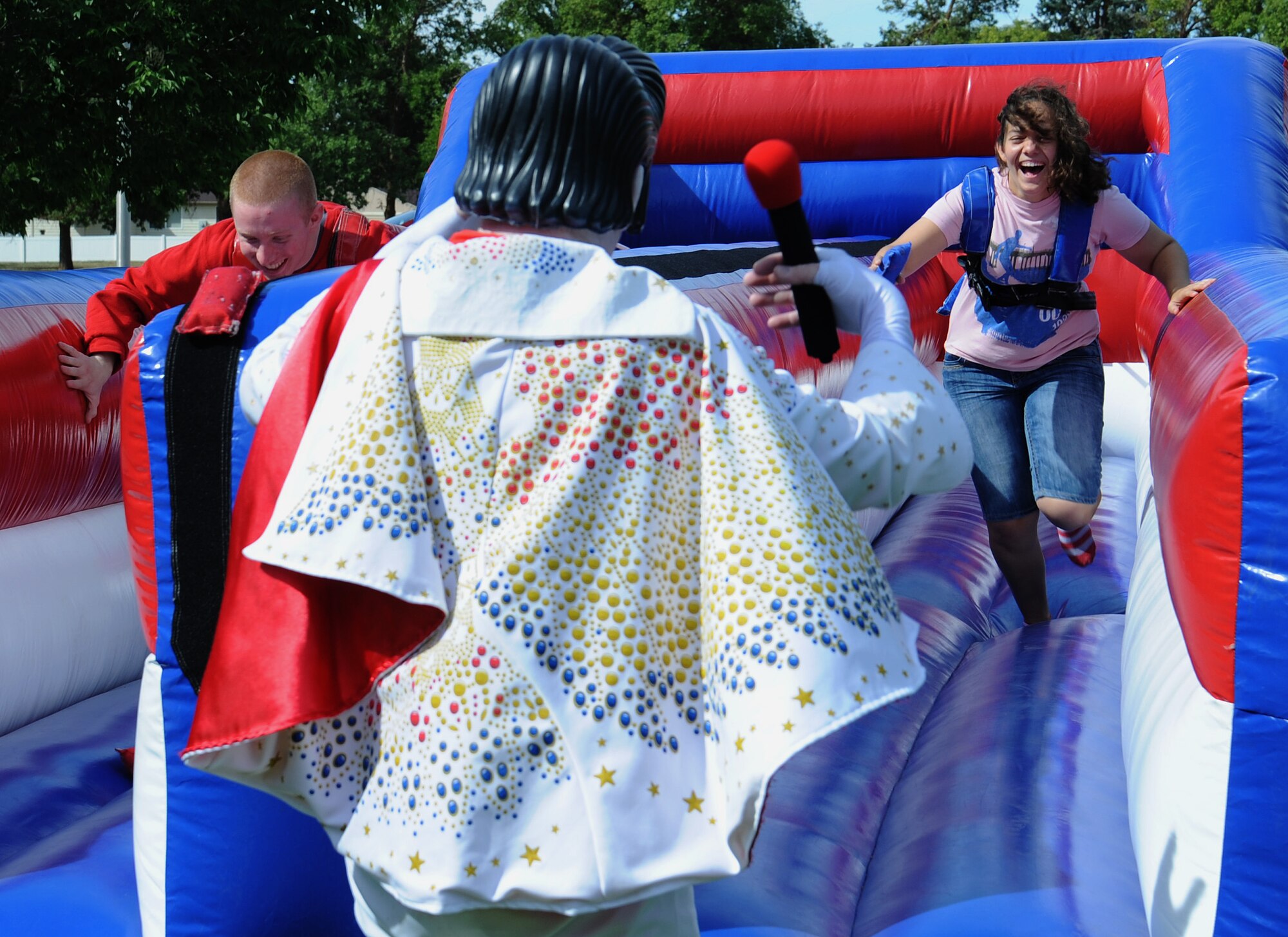 Fairchild youth race on an inflatable track during the End of Summer Bash in Miller Park at Fairchild Air Force Base, Washington, Aug. 28, 2014. The party, hosted by the 92nd Force Support Squadron, included food, games, pony rides, live entertainment, trike race and mechanical bull. (U.S. Air Force photo by Staff Sgt. Samantha Krolikowski/Released)