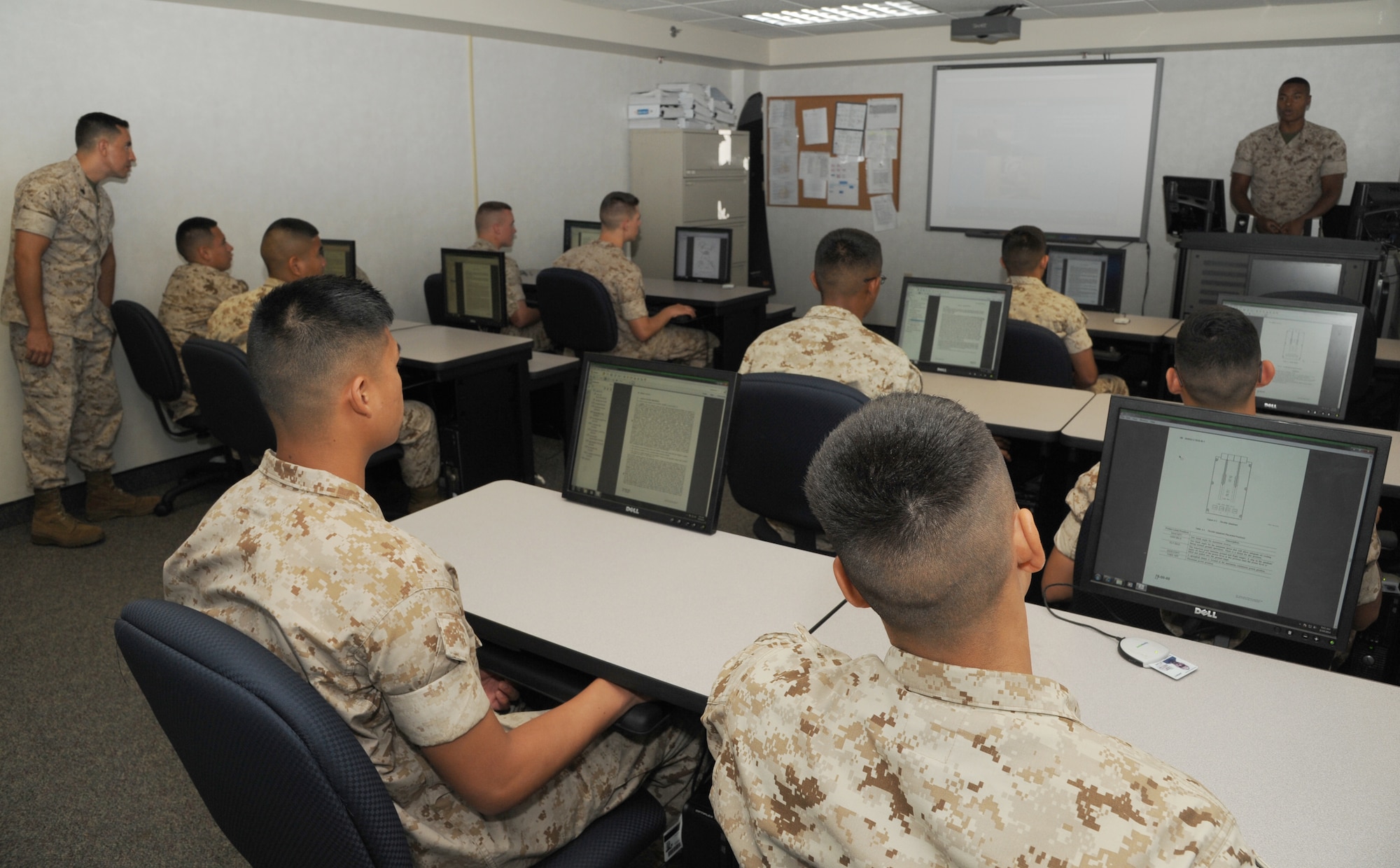 Students receive classroom training from their instructor August 19, 2014, at Little Rock Air Force Base, Ark. Marines train at Little Rock AFB to become specialized technicians at the Center for Naval Aviation Technical Training. (U.S. Air Force photo by Airman 1st Class Mercedes Muro) 