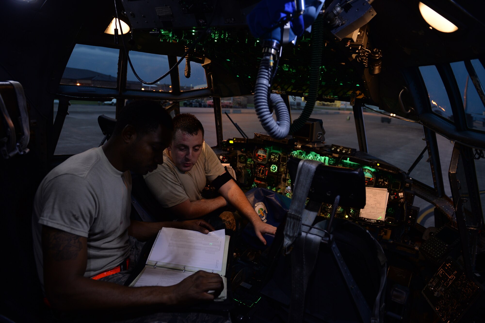 Staff Sgt. Cody Hampton and Senior Airman Craig Green, both 314th Aircraft Maintenance Squadron crew chiefs, look over aircraft forms to ensure no discrepancies have been over looked Aug. 18, 2014, at Little Rock Air Force Base, Ark. Maintainers certify that all C-130 aircraft are safe, functioning properly and ready to meet training and operational requirements. (U.S. Air Force photo by Airman 1st Class Cliffton Dolezal)