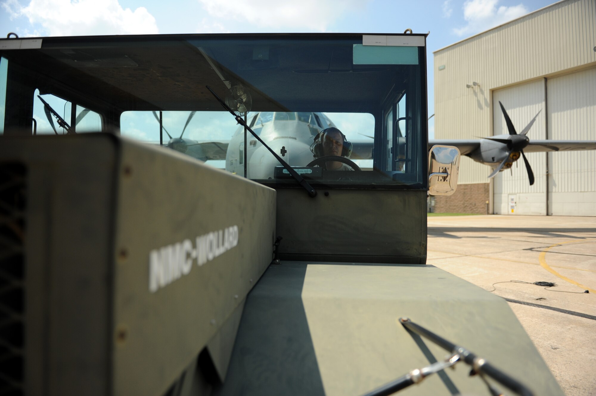 Senior Airman Joseph Sprowls, a 314th Aircraft Maintenance Squadron maintenance journeyman, tows a C-130J from a hangar, back to the flightline after an inspection Aug. 6, 2014, at Little Rock Air Force Base, Ark. The Airmen of the 314th AMXS work round the clock to ensure the world’s largest C-130 fleet is fit to fly. (U.S. Air Force photo by Airman 1st Class Scott Poe)
