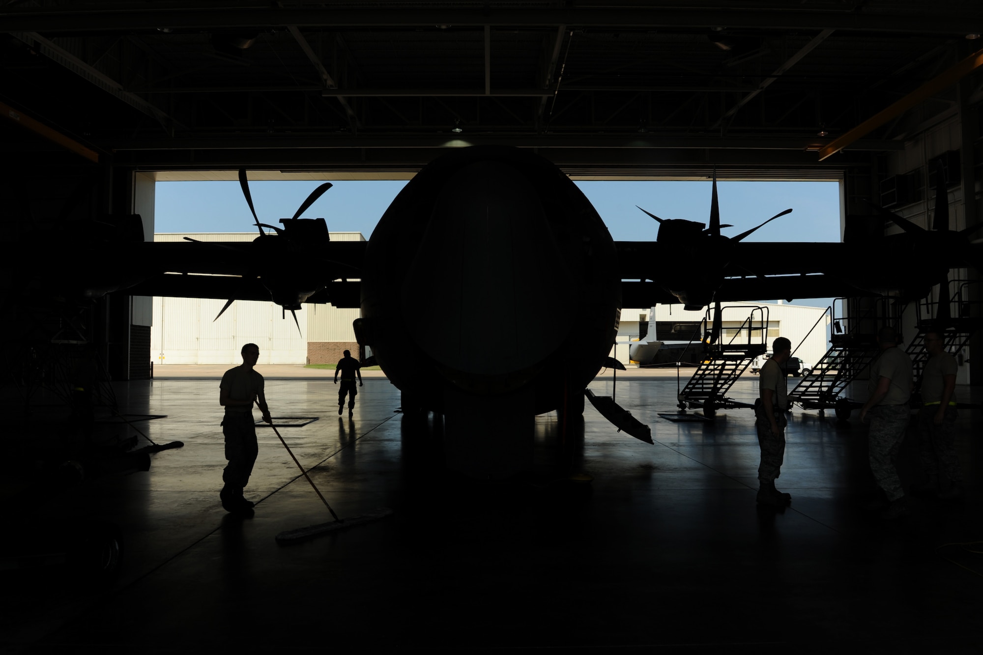 Maintainers from the 314th Aircraft Maintenance Squadron clean up their shop after inspecting a C-130J to determine its flight status Aug. 6, 2014, at Little Rock Air Force Base, Ark. By ensuring all aircraft are mission-ready, pilots in training receive essential flying hours. (U.S. Air Force photo by Airman 1st Class Scott Poe)