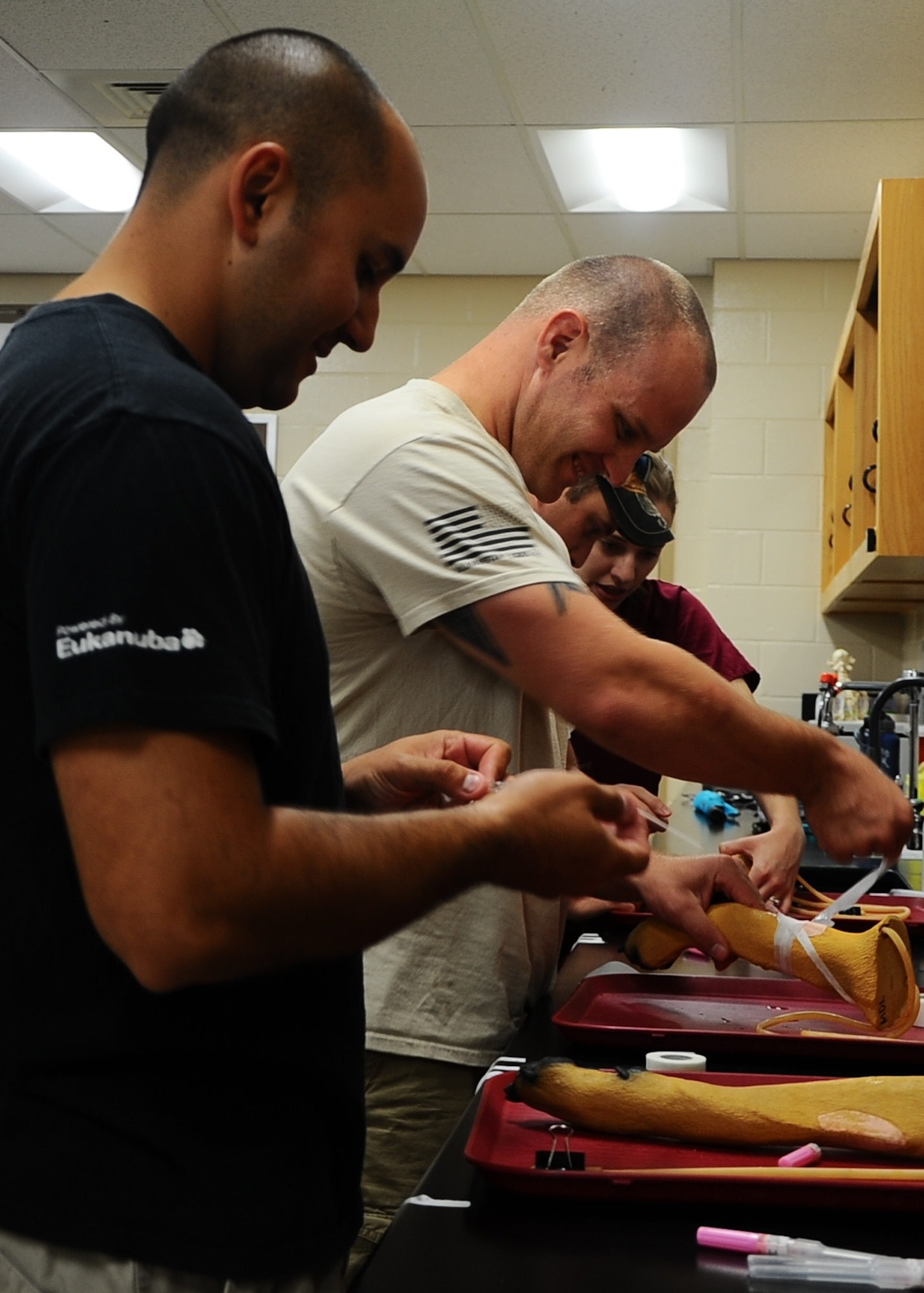 Staff Sgt. David MacDonald, 19th Security Forces Squadron military working hog handler, works alongside other military working dog handlers from various bases in a veterinary training event held Aug. 23 at the Mississippi State University College of Veterinary Medicine, Starkville, Miss. The training focused on teaching the handlers skills such as CPR, how to bandage injuries, and wound care. (U.S. Air Force photo by Senior Airman Stephanie Englar)