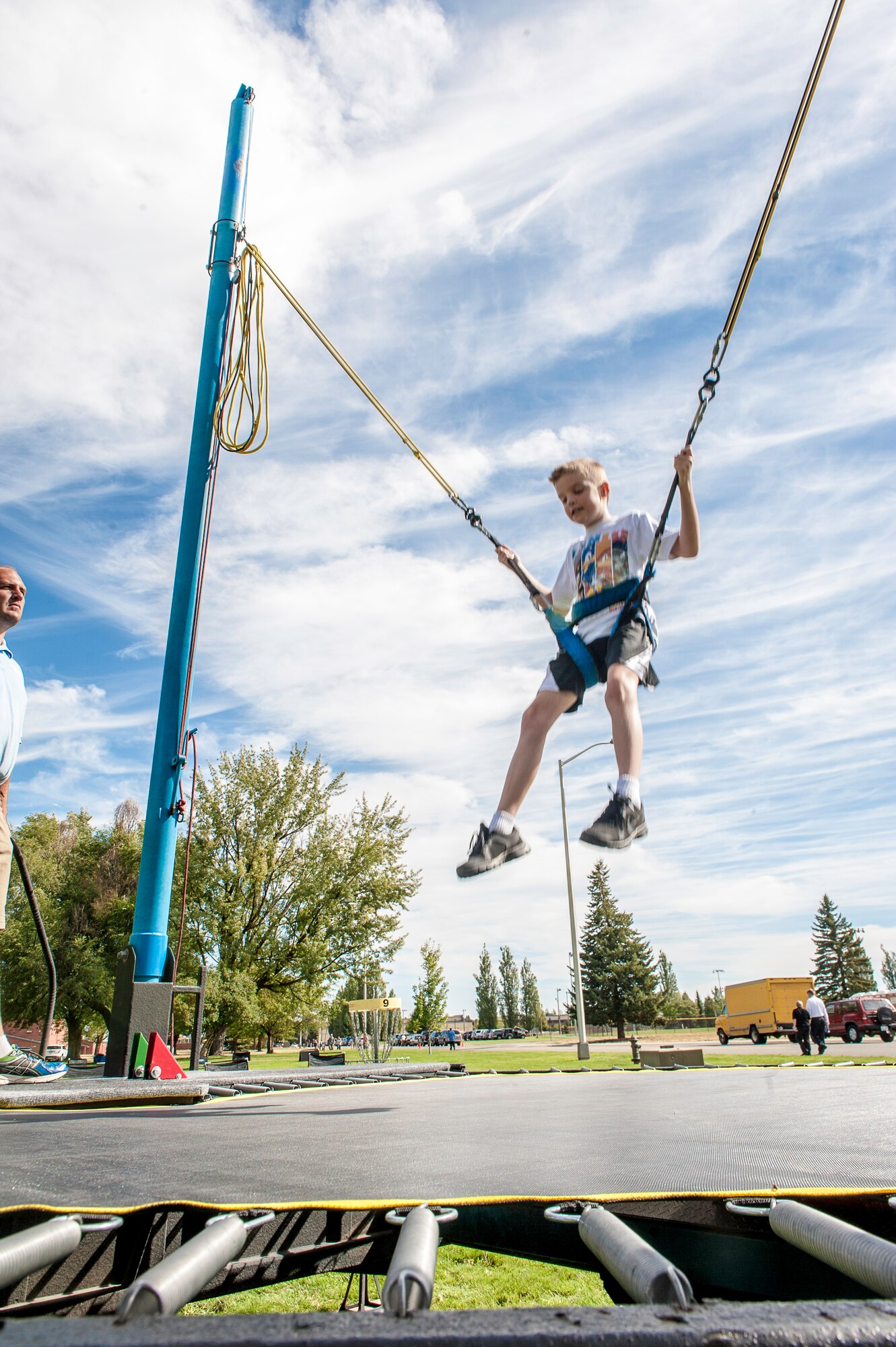Fairchild families had an opportunity to jump sky high on the super trampoline during the End of Summer Bash in Miller Park at Fairchild Air Force Base, Washington, Aug. 28, 2014. The party, hosted by the 92nd Force Support Squadron, included food, games, laser tag, pony rides, a giant trike race, live entertainment and inflatables for all ages. (U.S. Air Force photo by Staff Sgt. Benjamin W. Stratton/Released)