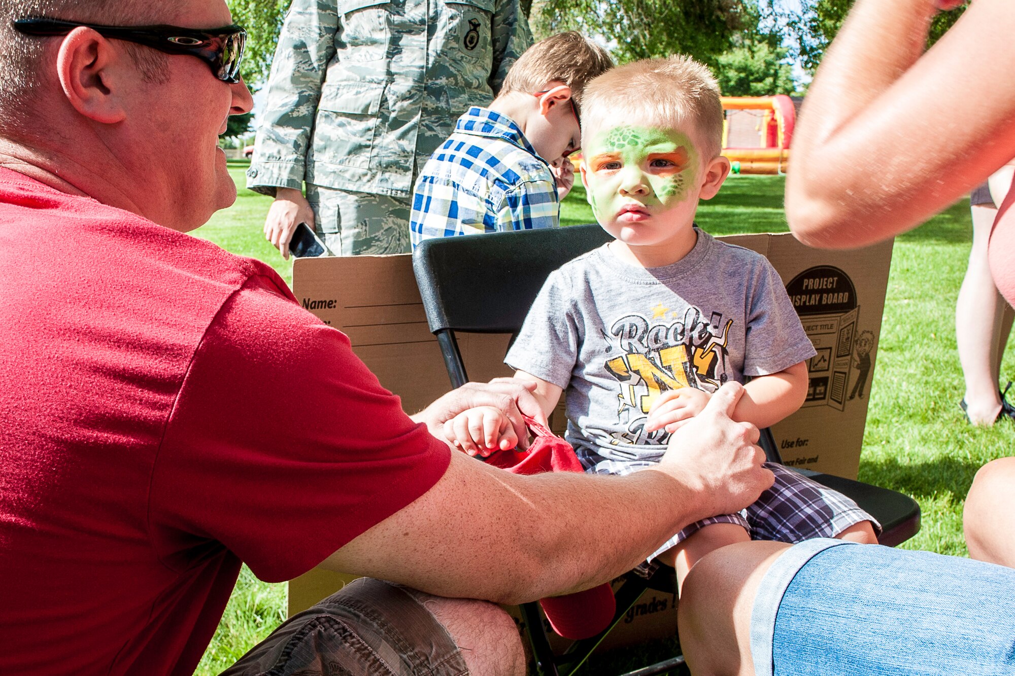 Fairchild families had an opportunity to get their faces painted during the End of Summer Bash in Miller Park at Fairchild Air Force Base, Washington, Aug. 28, 2014. The party, hosted by the 92nd Force Support Squadron, included food, games, laser tag, pony rides, a giant trike race, live entertainment and inflatables for all ages. (U.S. Air Force photo by Staff Sgt. Benjamin W. Stratton/Released)