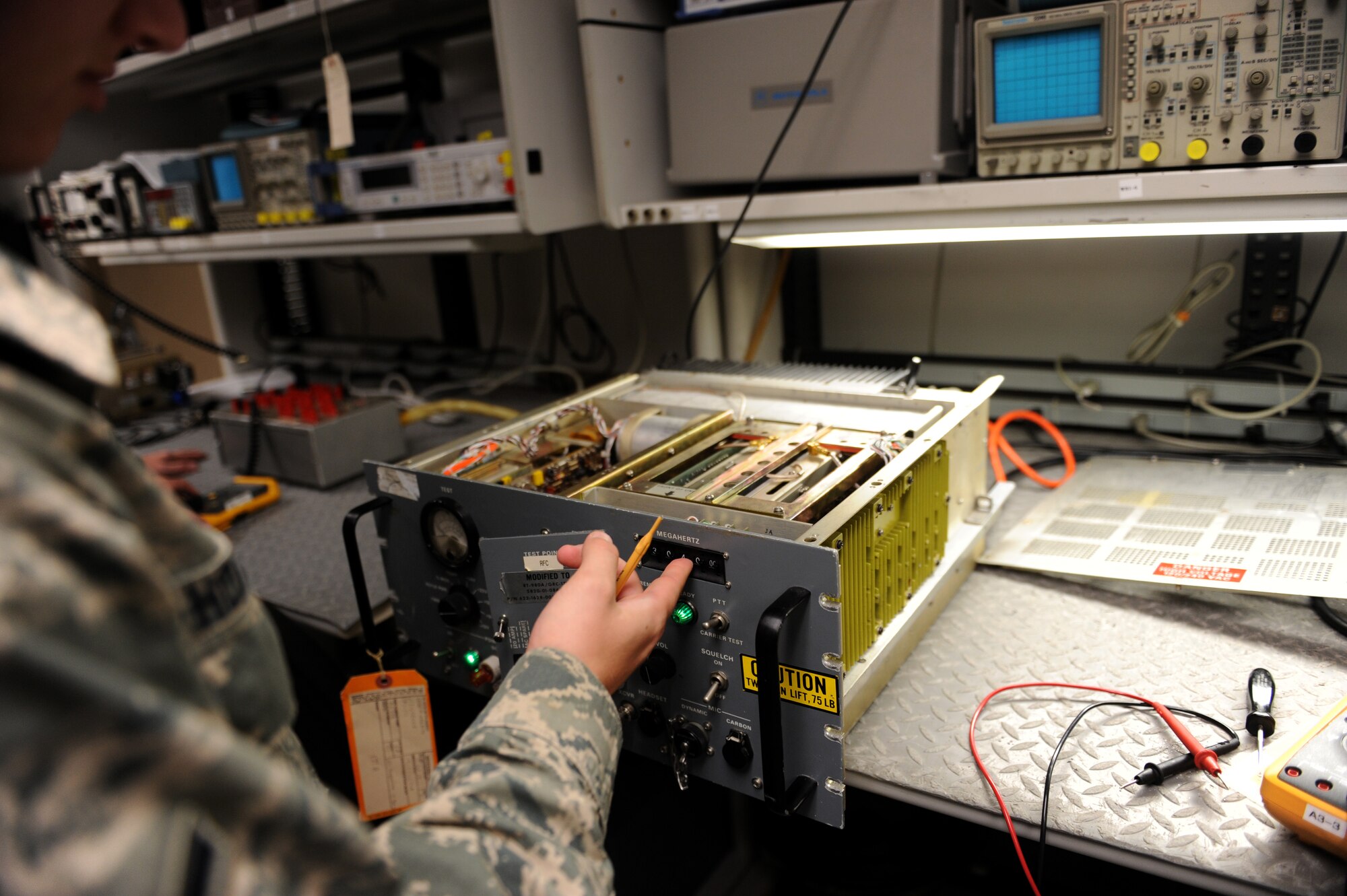 Airman Tucker Hoaglund, a 19th Operations Support Squadron airfield systems technician, performs annual operational checks on a transceiver radio Aug. 20, 2014, at Little Rock Air Force Base, Ark. It is important to routinely check equipment in order to ensure everything is functioning properly. (U.S. Air Force photo by Airman 1st Class Scott Poe)  