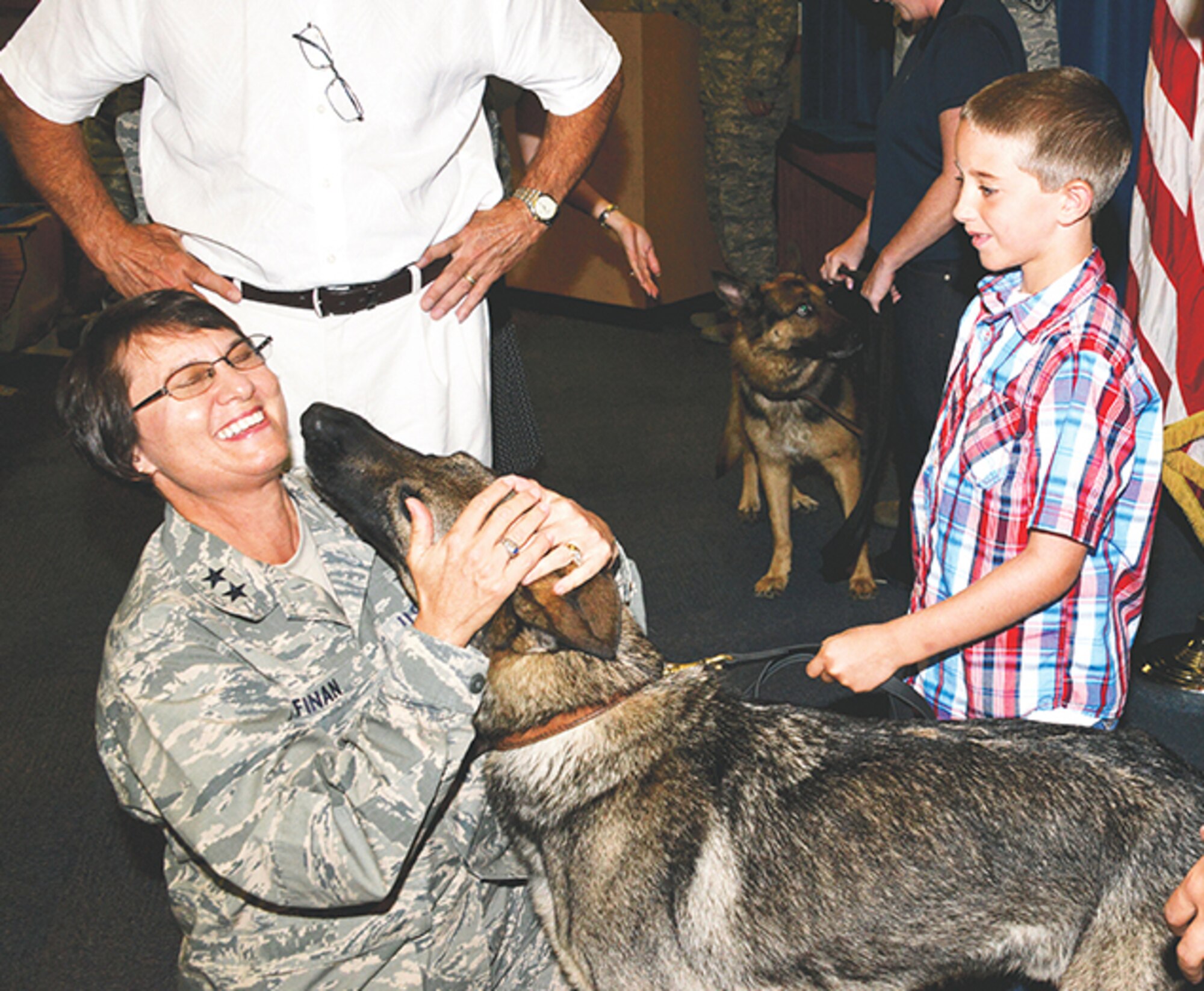 Brandon Wilson, new owner of Dan, a retiring working dog, shares his pet with Maj. Gen. Sandra Finan, Air Force Nuclear Weapons Center commander. (Photo by Dennis Carlson) 