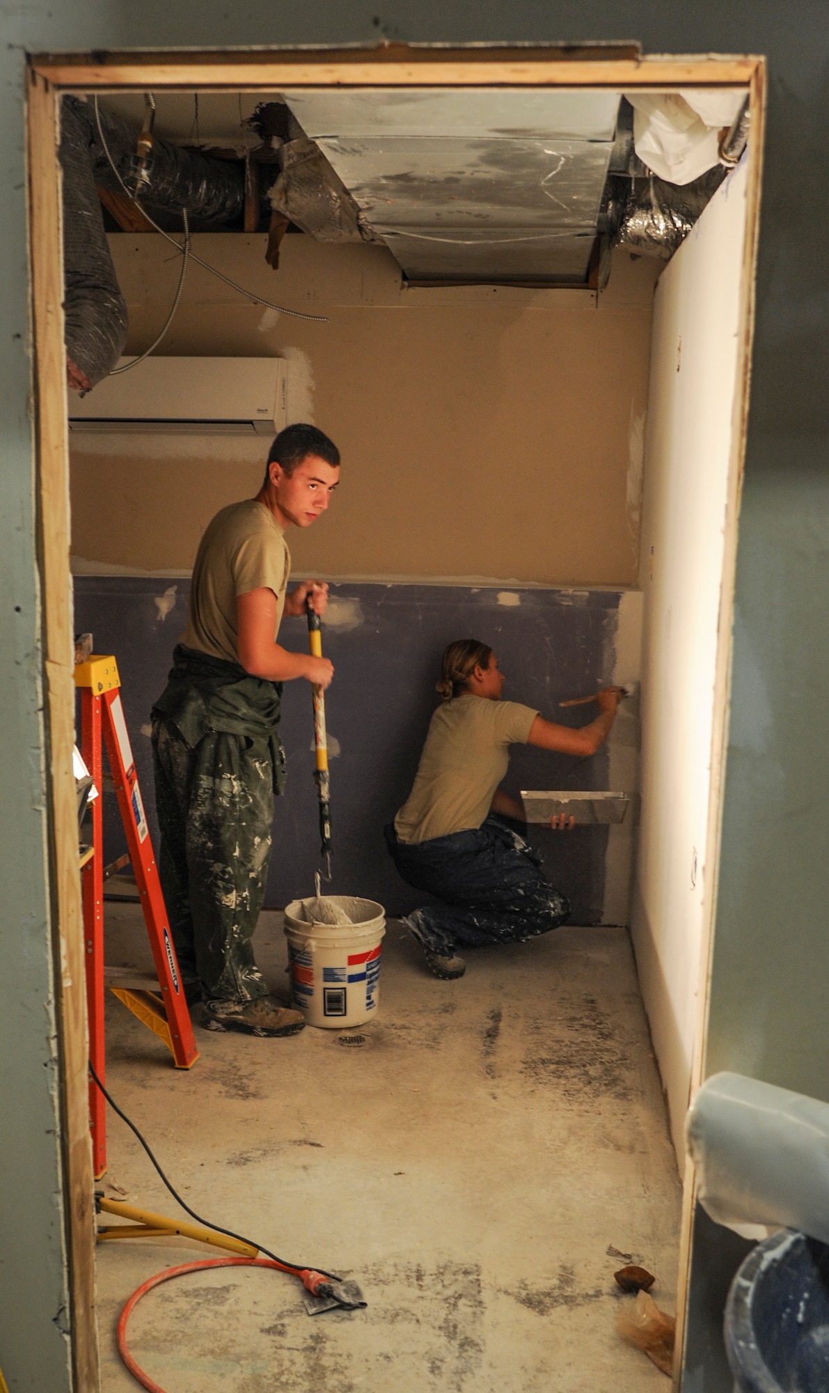 Airman 1st Class Devan Corneail, a 19th Civil Engineer Squadron structural journeyman (left), and Senior Airman Maria Brekkestran, a 19th CES structural apprentice, paint a bathroom Aug. 18, 2014, at Little Rock Air Force Base, Ark. The restroom was built entirely by CE Airmen, as part of annual readiness training. (U.S. Air Force photo by Airman 1st Class Harry Brexel) 