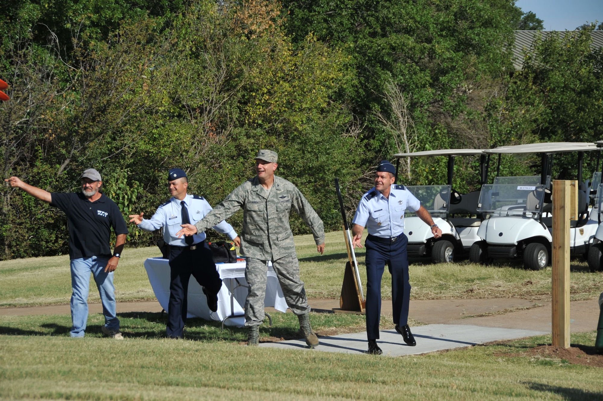 Jack Banks, president of the Wichita Falls Disc Golf Association, Brig. Gen. Scott Kindsvater, 82nd Training Wing commander, Col. Lance Bunch, 80th Flying Training Wing commander and Lt. Col. Joseph Chargualaf, 82nd Force Support Squadron commander, made the inaugural disc toss that opened the new disc golf course. Sheppard Air Force Base, Texas, is now home to a new 18-hole disc golf course, replacing the original golf course which closed in June due to a change in Defense Department policy. Sheppard partnered with the Wichita Falls Disc Golf Association to complete the project. (U.S. Air Force photo/Airman 1st Class Robert L. McIlrath)