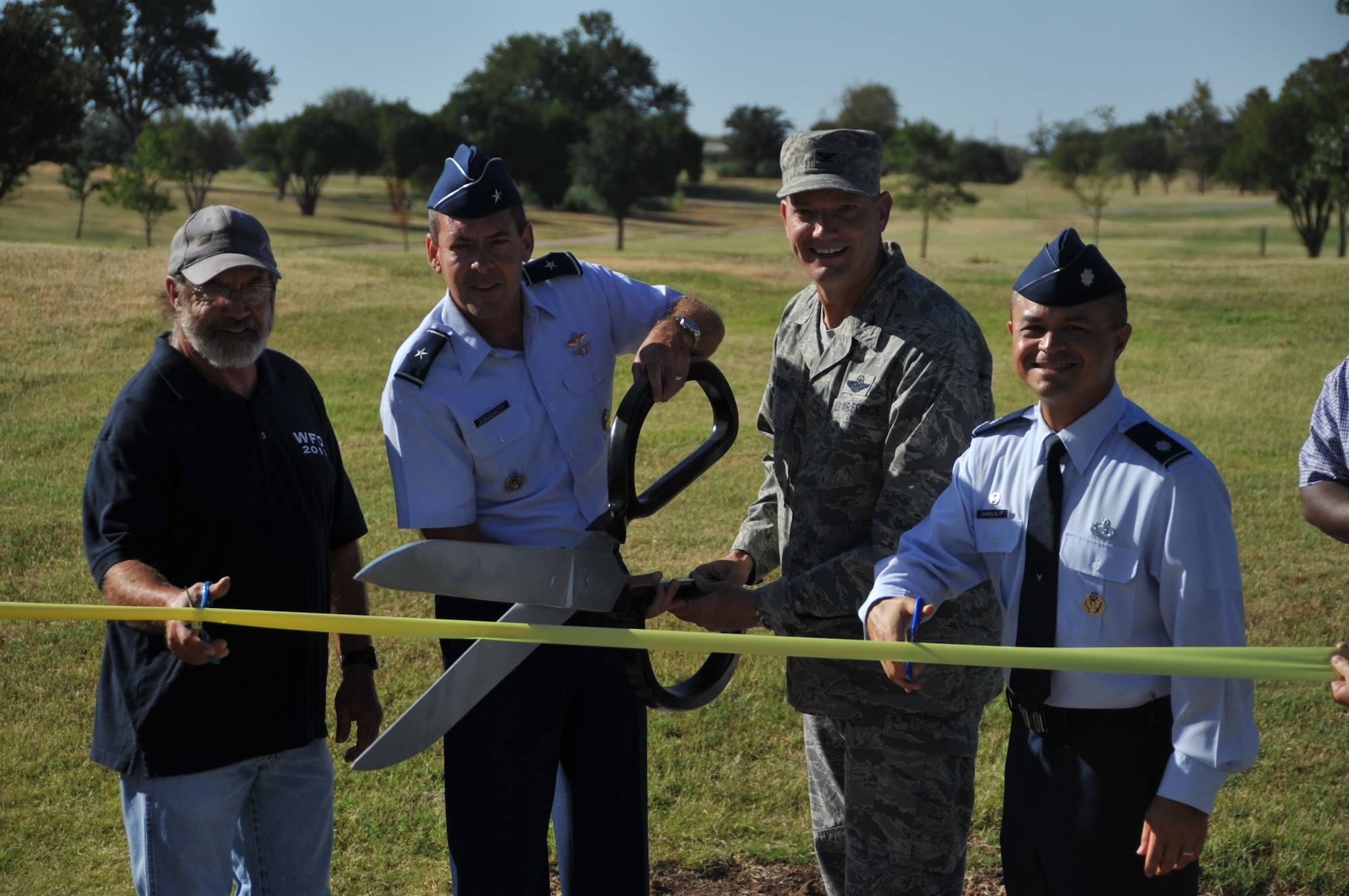 Jack Banks, president of the Wichita Falls Disc Golf Association, Brig. Gen. Scott Kindsvater, 82nd Training Wing commander, Col. Lance Bunch, 80th Flying Training Wing commander and Lt. Col. Joseph Chargualaf, 82nd Force Support Squadron commander, ceremonially opened the newly transformed Wind Creek Park Aug. 25, 2014, during an official ribbon cutting ceremony introducing the disc golf course to Sheppard Air Force Base, Texas. The base partnered with the Wichita Falls Disc Golf Association to complete the project. (U.S. Air Force photo/Airman 1st Class Robert L. McIlrath)
