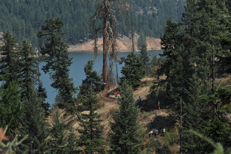 Airmen from the 22nd Training Squadron clear trail paths with family and friends as part of their resiliency and team-building activity on Tubbs Hill in Coeur d’Alene, Idaho, August 11, 2014. A team of about 30 volunteers from the 22nd TRS and SERE Solutions Inc., along with family friends, participated in a two day team building and resiliency event that ended with an overnight stay at a local campground, followed by a 15 mile bike ride down the historic Hiawatha Trail in Wallace, Idaho, that crosses the Montana border.  (U.S. Air Force photo by Staff Sgt. Alexandre Montes/Released)