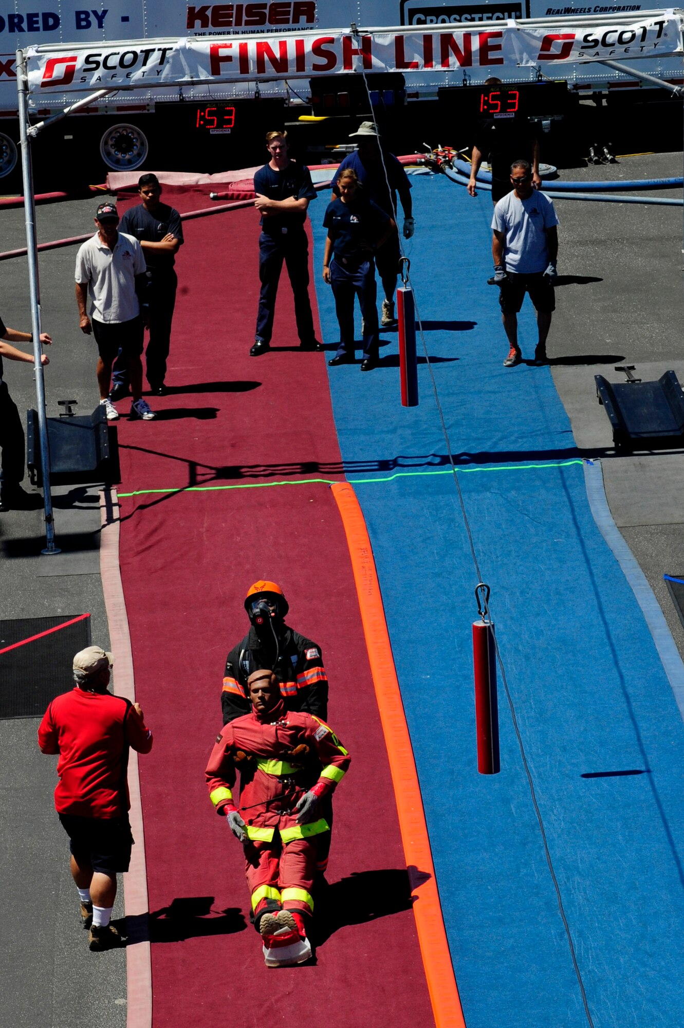 Lamont Brown, 30th Civil Engineering Squadron firefighter, approaches the finish line while simulating a victim rescue during the Scott Firefighter Combat Challenge, Aug. 22, 2014, Ontario, Calif. The five parts to the obstacle include a high-rise pack carry, hose hoist, forcible entry, hose advance and victim rescue. (U.S. Air Force photo by Senior Airman Shane Phipps/Released)