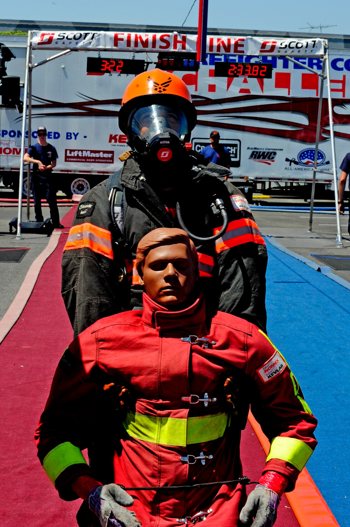 Essex Martinez, 30th Civil Engineering Squadron fire captain, simulates a victim rescue while participating in the Scott Firefighter Combat Challenge, Aug. 22, 2014, Ontario, Calif. A team of six firefighters from the 30th CES made the trip to compete in the challenge. (U.S. Air Force photo by Senior Airman Shane Phipps/Released)