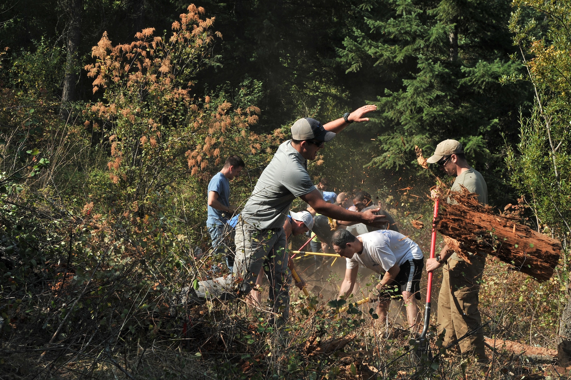 Airmen from the 22nd Training Squadron clear trail paths with family and friends as part of their resiliency and team-building activity on Tubbs Hill in Coeur d’Alene, Idaho, August 11, 2014. A team of about 30 volunteers from the 22nd TRS and SERE Solutions Inc., along with family friends, participated in a two day team building and resiliency event that ended with an overnight stay at a local campground, followed by a 15 mile bike ride down the historic Hiawatha Trail in Wallace, Idaho, that crosses the Montana border.  (U.S. Air Force photo by Staff Sgt. Alexandre Montes/Released)