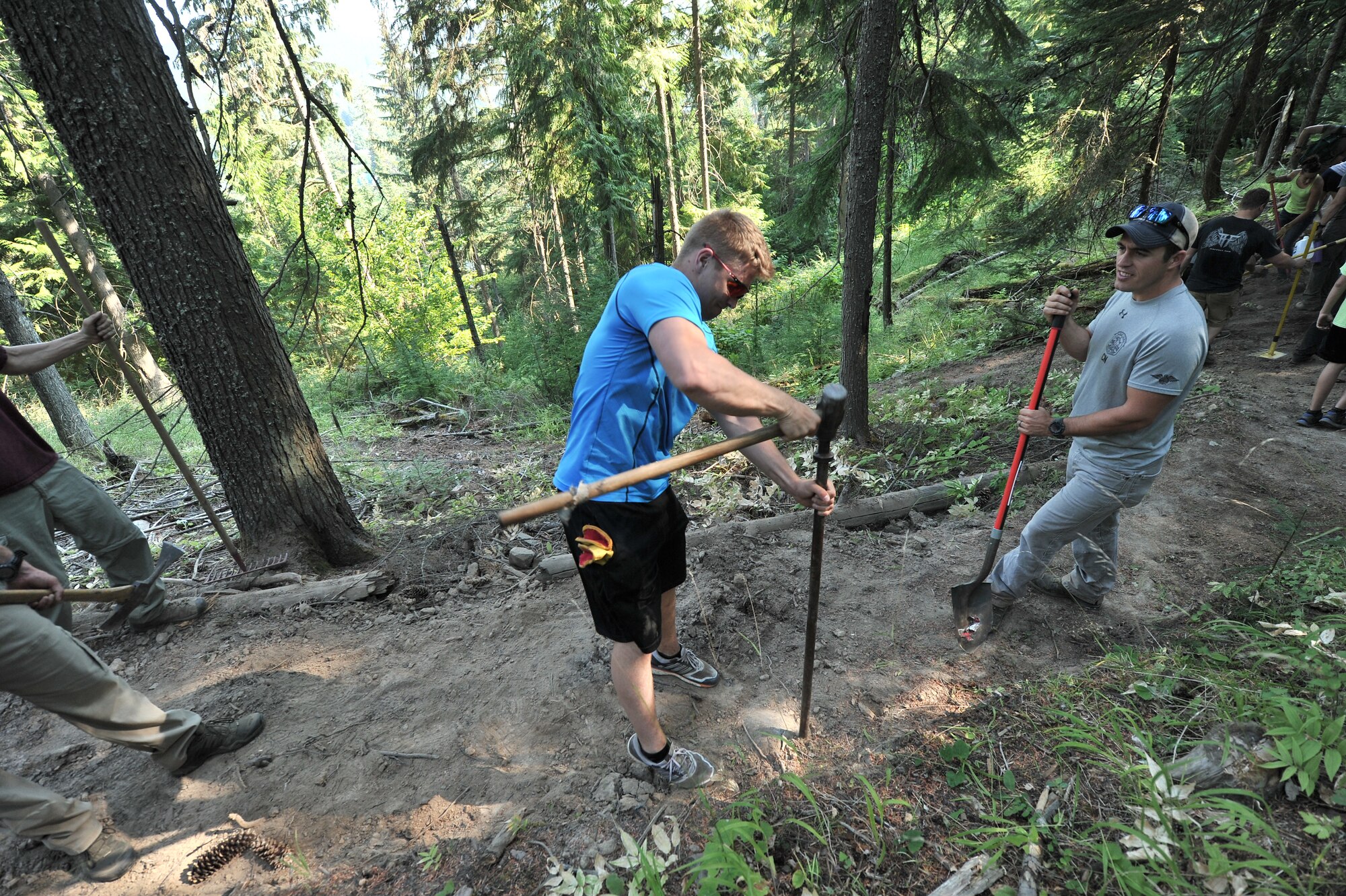 Airmen from the 22nd Training Squadron clear trail paths with family and friends as part of their resiliency and team-building activity on Tubbs Hill in Coeur d’Alene, Idaho, August 11, 2014. A team of about 30 volunteers from the 22nd TRS and SERE Solutions Inc., along with family friends, participated in a two day team building and resiliency event that ended with an overnight stay at a local campground, followed by a 15 mile bike ride down the historic Hiawatha Trail in Wallace, Idaho, that crosses the Montana border.  (U.S. Air Force photo by Staff Sgt. Alexandre Montes/Released)