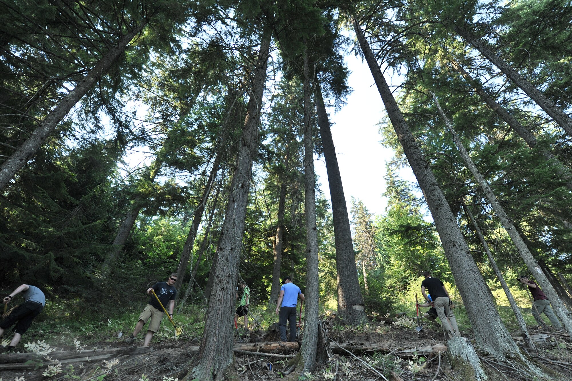 Airmen from the 22nd Training Squadron clear trail paths with family and friends as part of their resiliency and team-building activity on Tubbs Hill in Coeur d’Alene, Idaho, August 11, 2014. A team of about 30 volunteers from the 22nd TRS and SERE Solutions Inc., along with family friends, participated in a two day team building and resiliency event that ended with an overnight stay at a local campground, followed by a 15 mile bike ride down the historic Hiawatha Trail in Wallace, Idaho, that crosses the Montana border.  (U.S. Air Force photo by Staff Sgt. Alexandre Montes/Released)