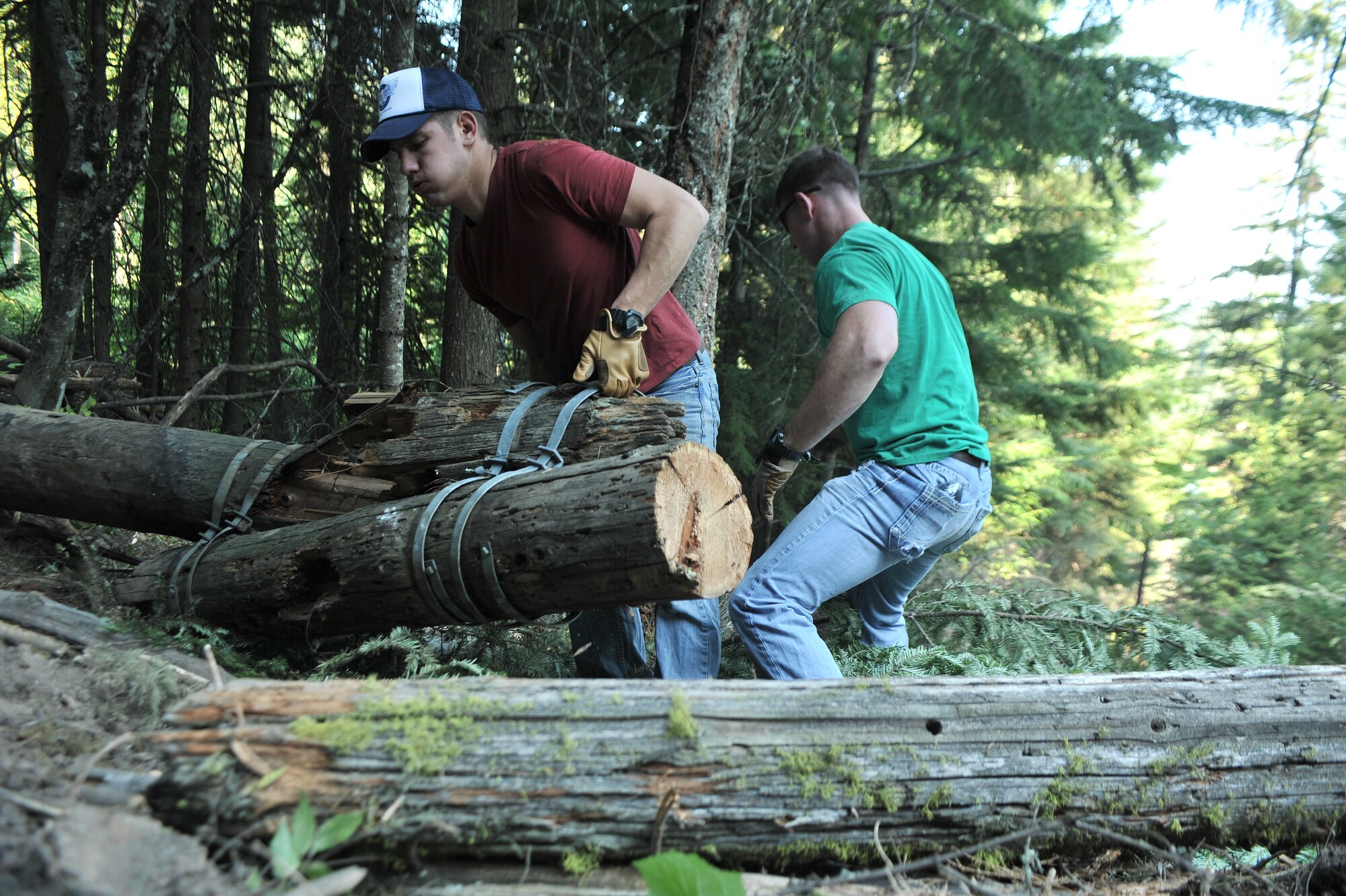 Airmen from the 22nd Training Squadron clear trail paths with family and friends as part of their resiliency and team-building activity on Tubbs Hill in Coeur d’Alene, Idaho, August 11, 2014. A team of about 30 volunteers from the 22nd TRS and SERE Solutions Inc., along with family friends, participated in a two day team building and resiliency event that ended with an overnight stay at a local campground, followed by a 15 mile bike ride down the historic Hiawatha Trail in Wallace, Idaho, that crosses the Montana border.  (U.S. Air Force photo by Staff Sgt. Alexandre Montes/Released)