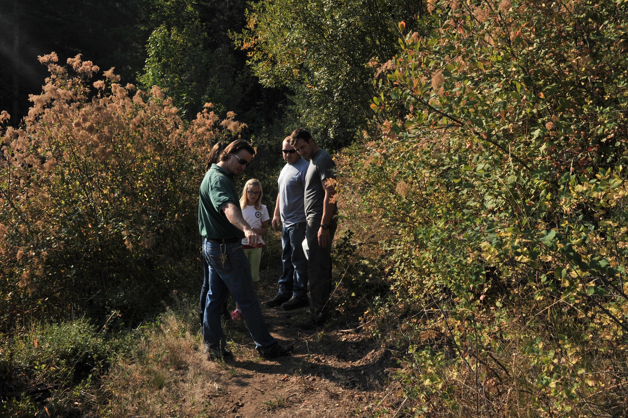 Monte McCuooy, Coeur d’Alene Parks and Recreation trails coordinator, explains to volunteers from the 22nd Training Squadron which parts of the trail need to be worked on during a resiliency and team-building activity on Tubbs Hill in Coeur d’Alene, Idaho August 11, 2014. A team of about 30 volunteers from the 22nd TRS and SERE Solutions Inc. along with family friends participated in a two day team building and resiliency event that overnight stay at a local campground with a (U.S. Air Force photo by Staff Sgt. Alexandre Montes/Released)