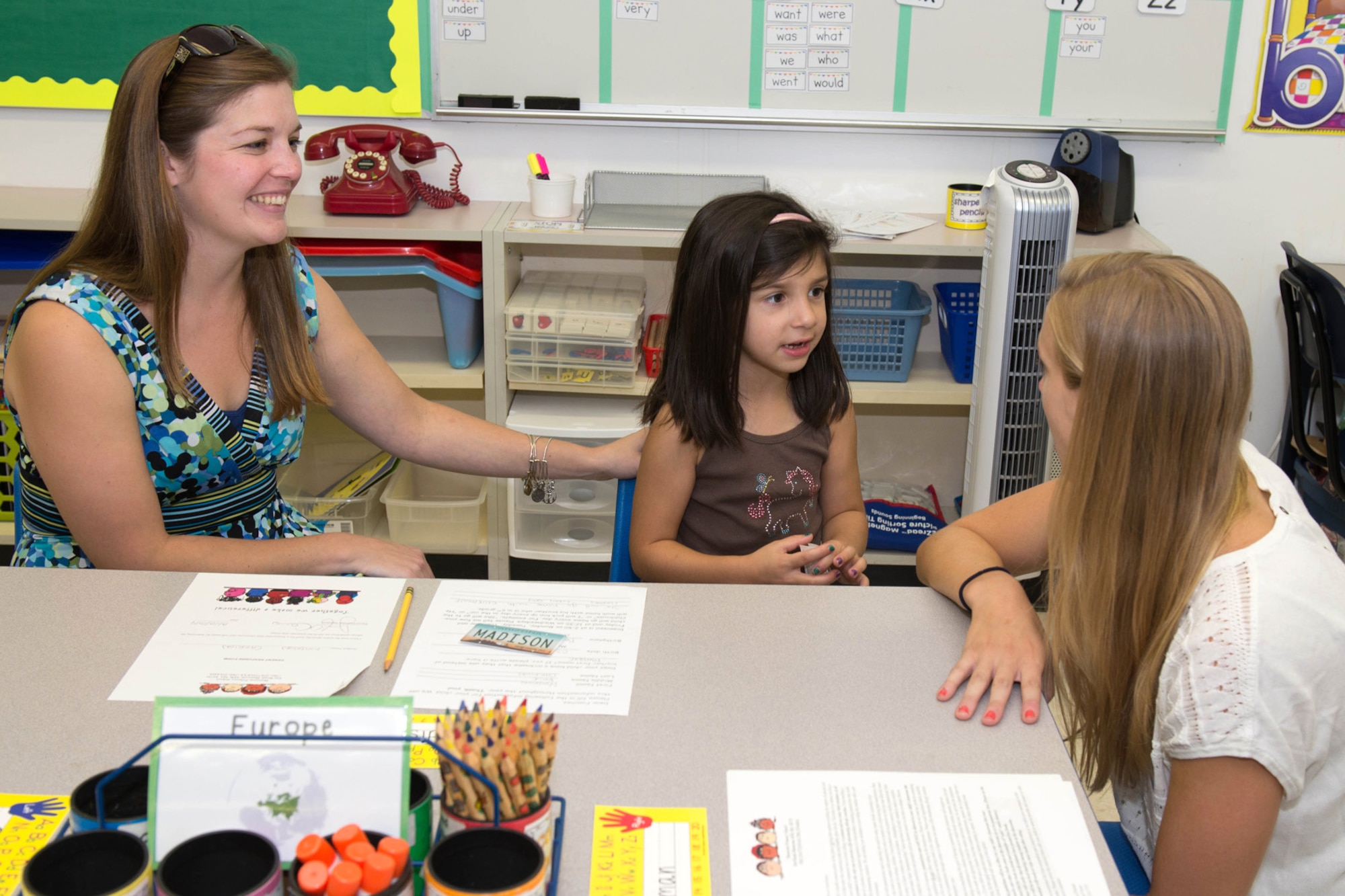 Rachael Peterson (right), a first grade teacher at the Hanscom Primary School, meets Jennifer Carrion and her daughter, Madison, during a "Meet and Greet" at the school Aug. 28. The primary and middle schools hosted the event as a way for parents and students to meet teachers, check class lists, purchase school spirit wear and find out more about the Parent Teacher Organization before the start of the new school year. (U.S. Air Force photo by Mark Herlihy)