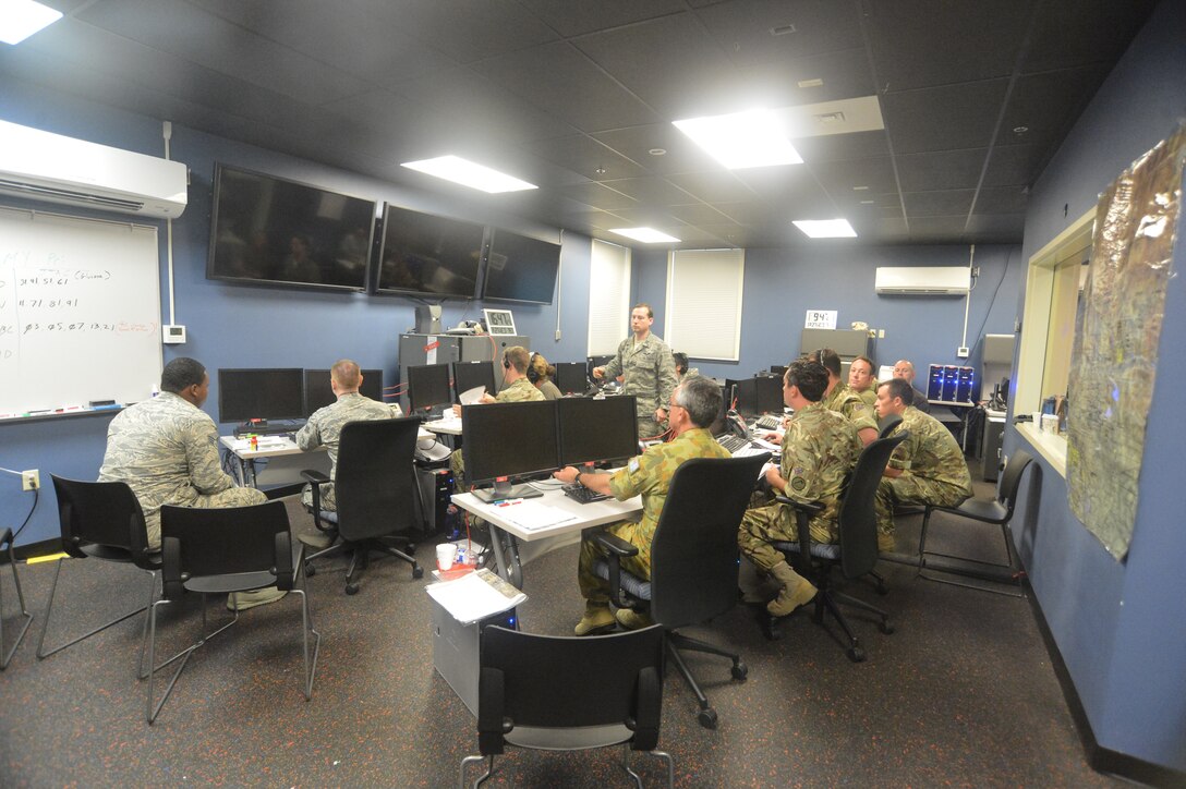 Members from the Air Force, British Royal Air Force, and Royal Australian Air Force work to strategize and send data on computers during exercise Coalition Virtual Flag Aug. 27, 2014, at Joint Base Lewis-McChord, Wash. Coalition Virtual Flag was a weeklong world-wide large-scale exercise on a network, created to simulate an operation plan in which Air Force and coalition service members worked together as they would in a deployed environment. (U.S. Air Force photo/ Airman 1st Class Keoni Chavarria)
