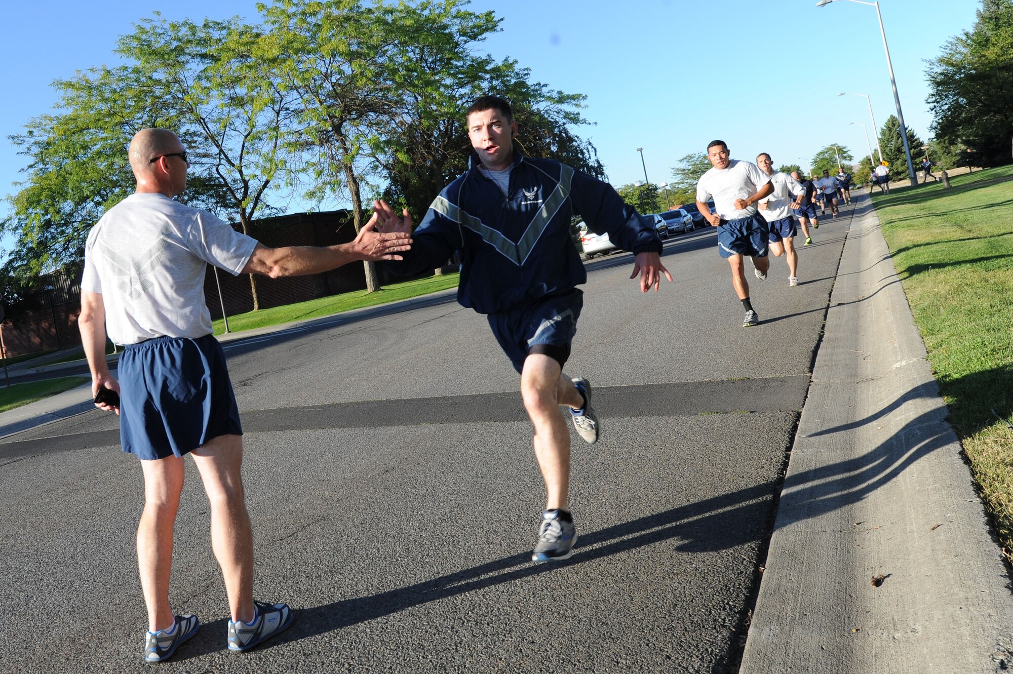 Airmen from units all over Fairchild run together at Fairchild Air Force Base, Washington, Aug. 28, 2014. There are a variety of periodic runs both official and unofficial that allow Airmen to personally assess their physical fitness and enhance unit cohesion through team morale and welfare. (U.S. Air Force photo by Airman 1st Class Janelle Patiño/Released)