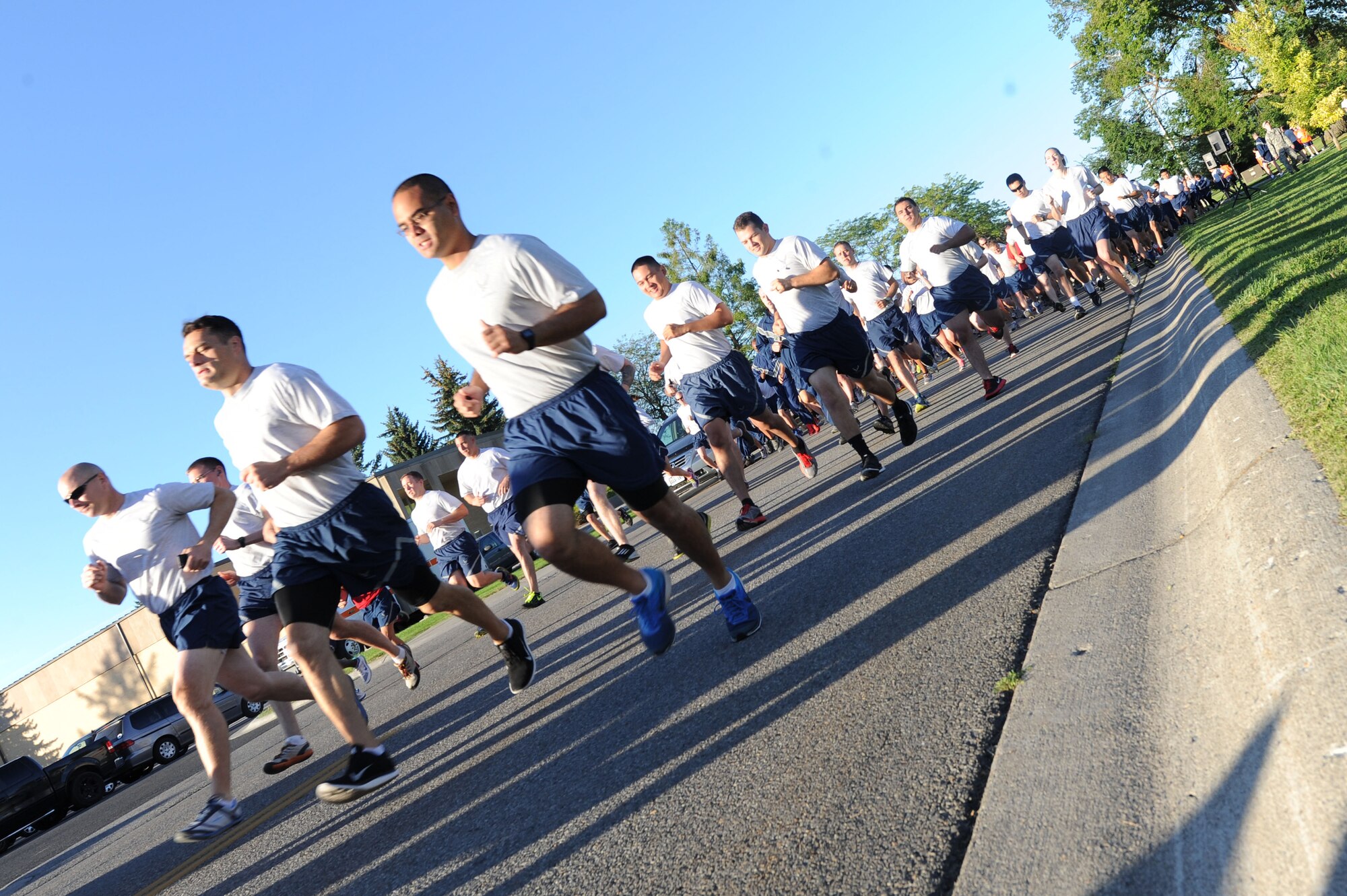 Airmen from units all over Fairchild run together at Fairchild Air Force Base, Washington, Aug. 28, 2014. There are a variety of periodic runs both official and unofficial that allow Airmen to personally assess their physical fitness and enhance unit cohesion through team morale and welfare. (U.S. Air Force photo by Airman 1st Class Janelle Patiño/Released)