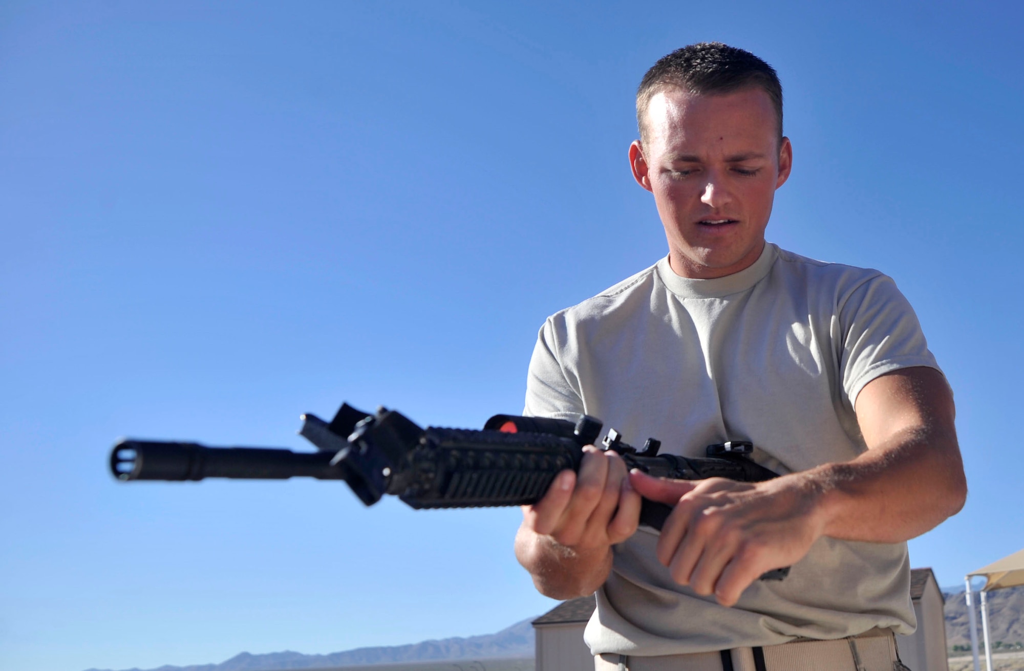 Staff Sgt. Derek Urban, 99th Contracting Squadron contract specialist, performs a function check on an M-4 Carbine during the Warrior Challenge Aug. 22, 2014, at Creech Air Force Base, Nev. The Warrior Challenge is part of the Life of a Warrior Campaign, which aims to promote the four pillars of resiliency for participants. (U.S. Air Force photo by Airman 1st Class Christian Clausen/Released)