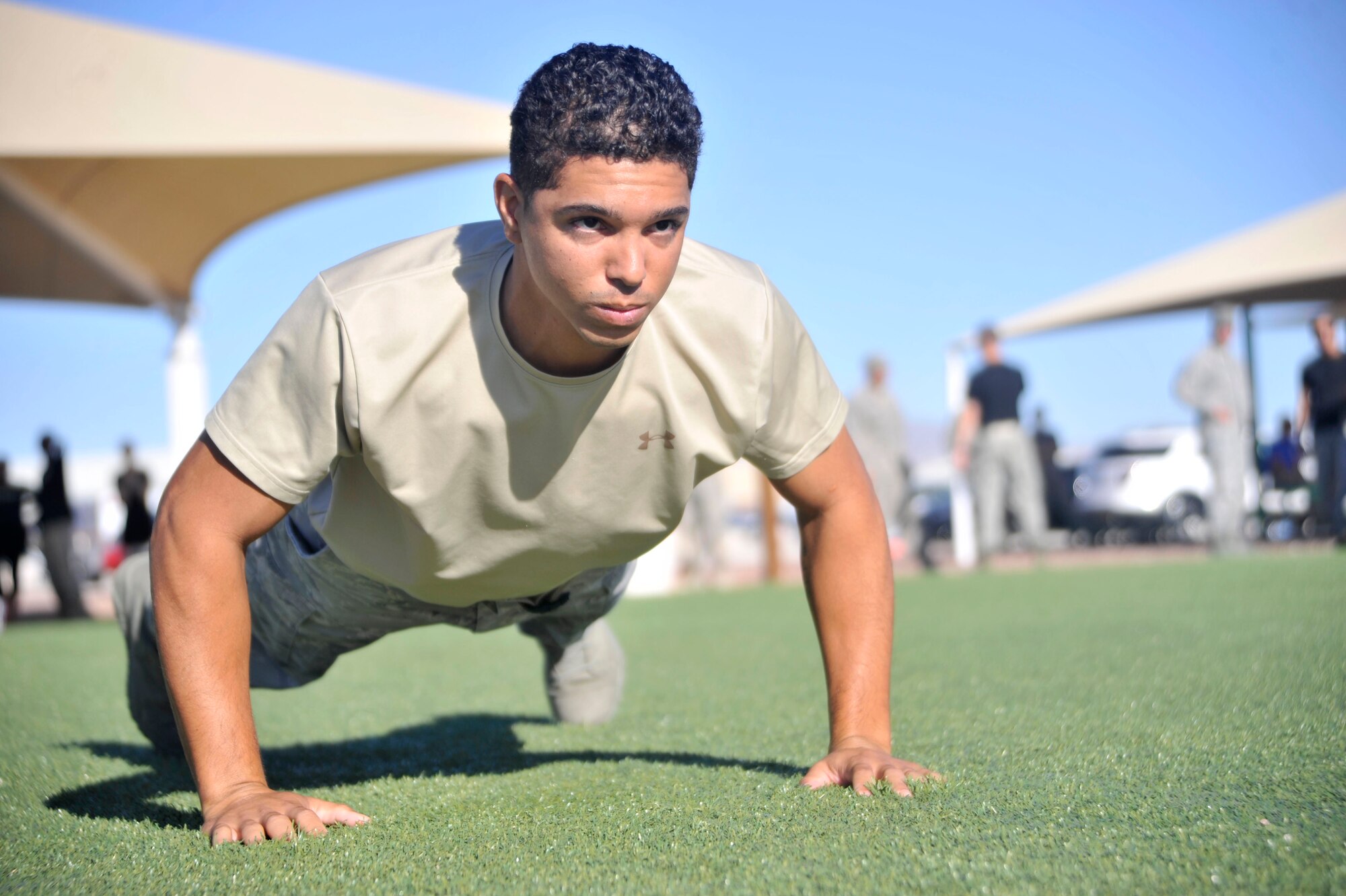 Tech. Sgt. Michael McGuire, 99th Contracting Squadron contract specialist, performs pushups during the Warrior Challenge Aug. 22, 2014, at Creech Air Force Base, Nev. The Warrior Challenge included pushups, weapons assembly, Humvee pushes, litter carries, ruck marches, and at the end, participants maneuvered around "enemy combatants" to the finish line. (U.S. Air Force photo by Airman 1st Class Christian Clausen/Released)