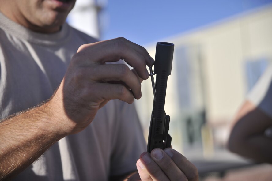 Staff Sgt. Brent Olson, 99th Ground Combat Training Squadron K-9 instructor, assembles the bolt carrier group of an M-4 Carbine during the first-ever Warrior Challenge hosted Aug. 22, 2014, on Creech Air Force Base, Nev. The Warrior Challenge takes place bimonthly and is part of the Life of a Warrior campaign, which aims to improve the four pillars of resiliency for its participants. (U.S. Air Force photo by Airman 1st Class Christian Clausen/Released)