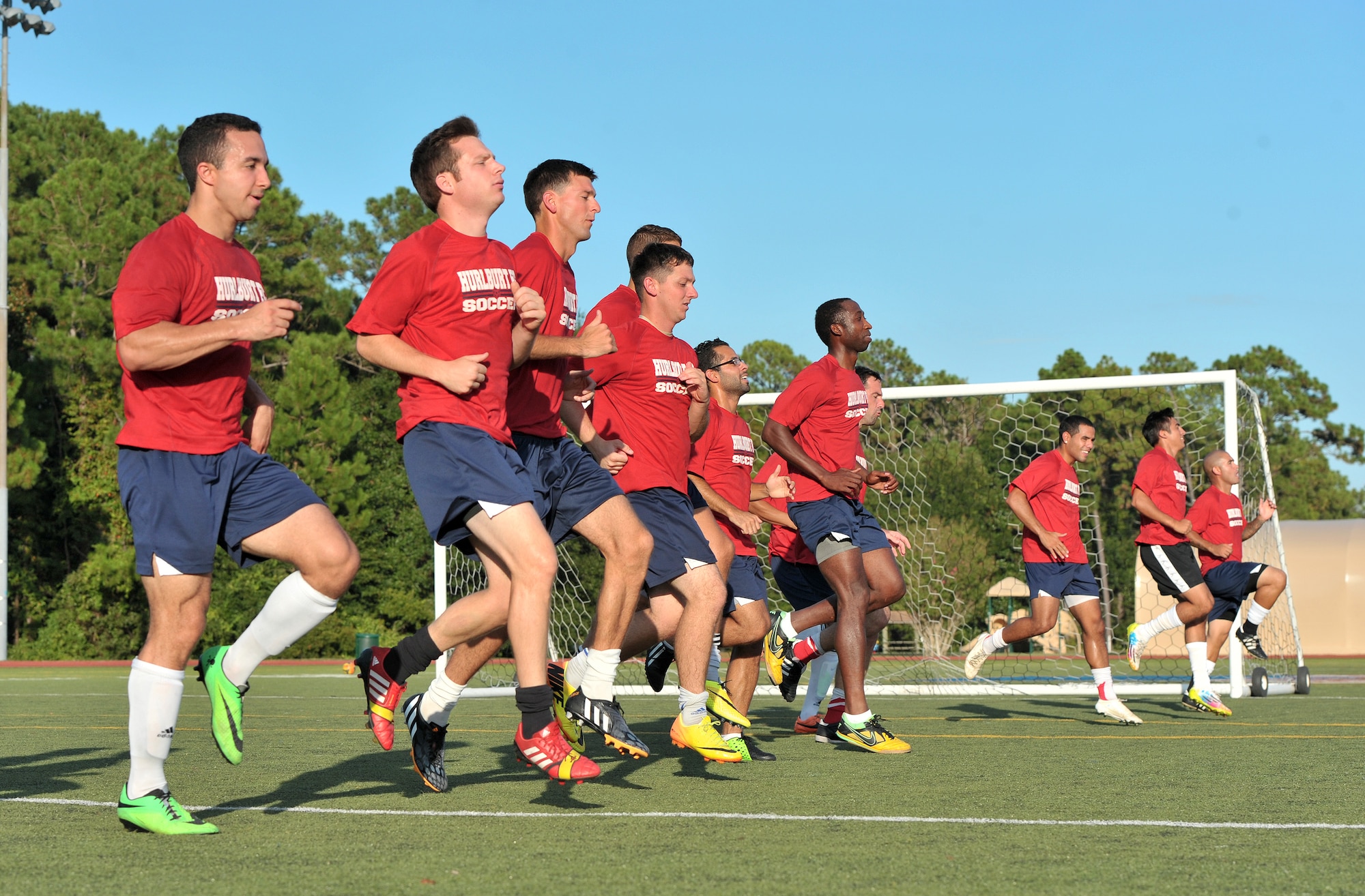 The Hurburt Field Soccer Team warms up with light jogs and sprints before beginning practice at the Aderholt Fitness Center Aug. 26, 2014. The players will be facing teams from other bases and services during the 2014 Department of Defense Soccer Tournament at Lackland Air Force Base, Texas this Labor Day weekend. (U.S. Air Force photo/Senior Airman Kentavist P. Brackin)