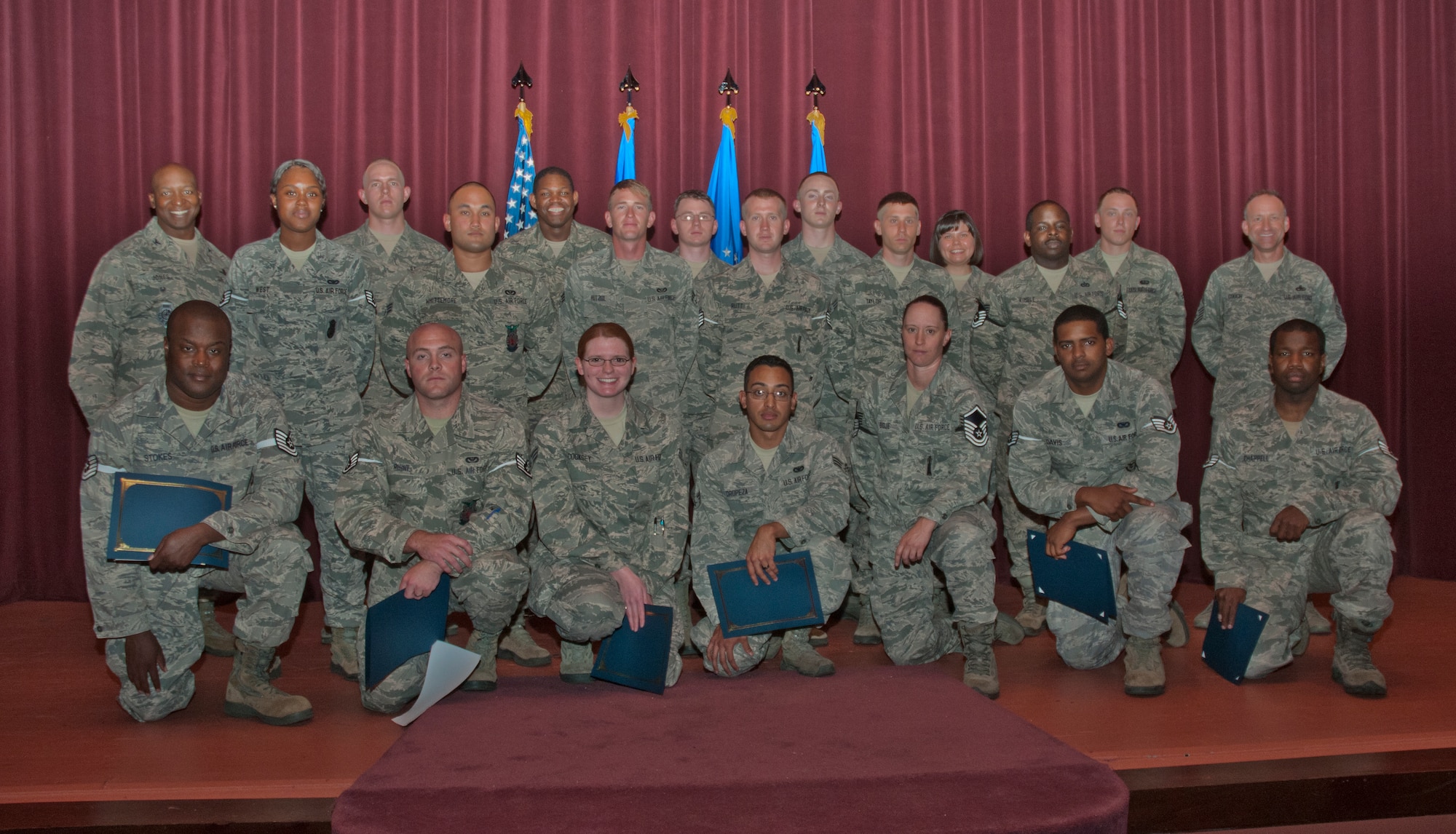 Enlisted 90th Missile Wing Airmen pose for a photo in the F.E. Warren Base Theater Aug. 27, 2014, during a congratulatory promotion ceremony for the enlisted Airmen who advanced in rank in August. (U.S. Air Force photo by Airman Malcolm Mayfield)