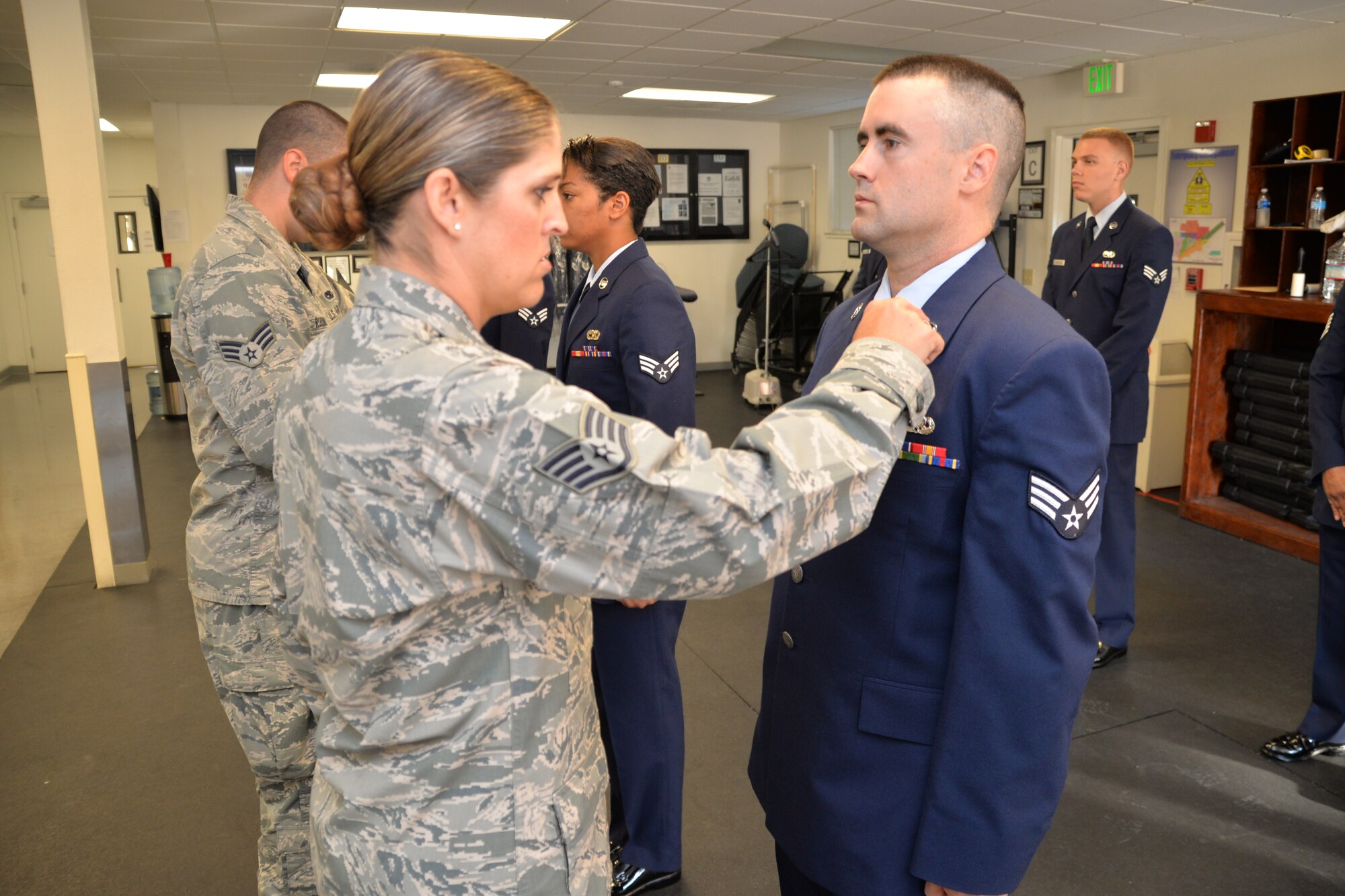 Staff Sgt. Tania McGuire, 349th Aircraft Maintenance Squadron and honor guard trainer, inspects the service dress uniform of Senior Airman Erik Blevins, 349th Aircraft Maintenance Squadron, to ensure his uniform is in proper standards. The Travis Honor Guard held a training class for members of the 349th Air Mobility Wing to increase wing participation in the program. (U.S. Air Force photo/Senior Airman Bryan Swink)