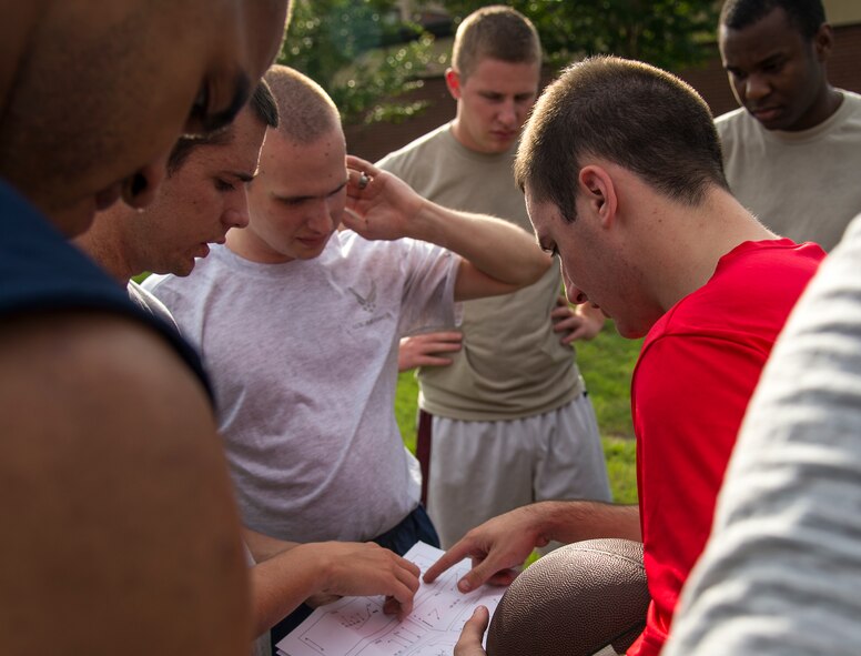Members of an intramural football team huddle during flag football practice at Moody Air Force Base, Ga., Aug. 27, 2014. Team members discussed positions and how to execute plays. 
(U.S. Air Force photo by Airman 1st Class Sandra Marrero/Released)
