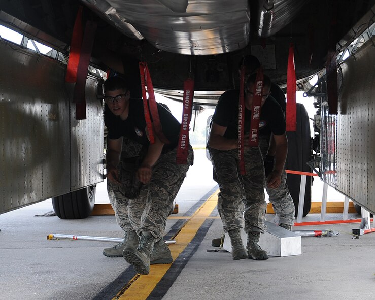 Airmen from the 2nd Aircraft Maintenance Squadron weapons load team perform a weapons load during the 2014 Global Strike Challenge on Barksdale Air Force Base, La., Aug. 26. The Global Strike Challenge is held to showcase the world's premier bomber and Intercontinental Ballistic Missile force, foster esprit de corps through competition and teamwork, recognize outstanding Air Force Global Strike Command personnel and improve combat capabilities. (U.S. Air Force photo/Staff Sgt. Sean Martin)