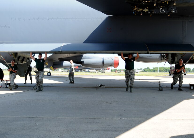 Airmen from the 2nd Aircraft Maintenance Squadron weapons load team open up the bomb bay of a B-52H Stratofortress during the 2014 Global Strike Challenge on Barksdale Air Force Base, La., Aug. 26.  The timed load consisted of the Airmen loading AGM-86 Air Launch Cruise Missiles into a B-52 using a common strategic rotary launcher. (U.S. Air Force photo/Staff Sgt. Sean Martin)
